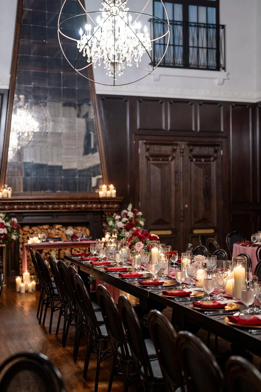 Wedding reception banquet table with candles and red and pink florals at the Ebell of Long Beach