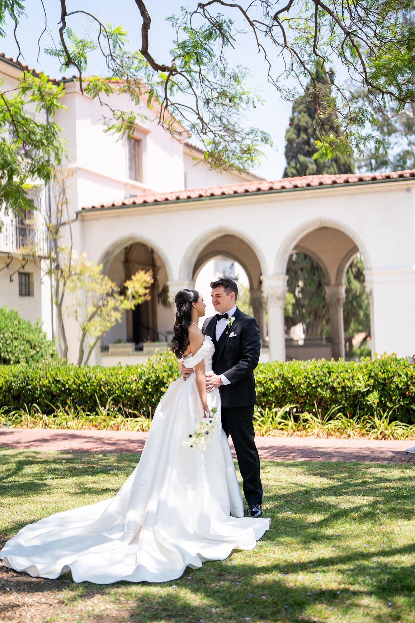 Wedding portraits of couple looking at each other with the Athenaeum at Caltech in background 8.