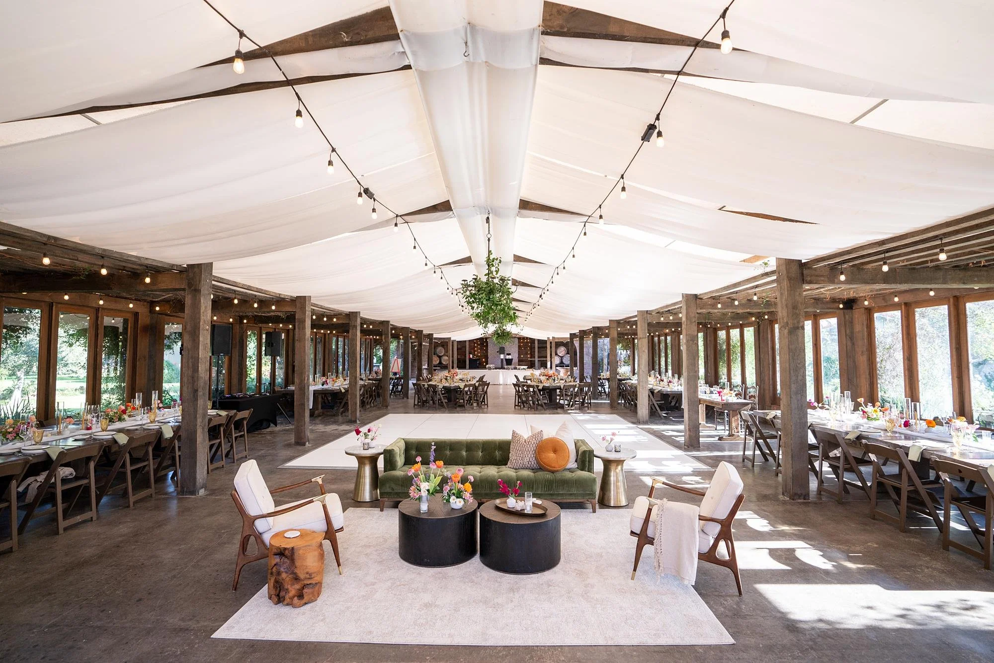 Wedding reception in the Pavilion at La Arboleda with custom lounge seating arranged at the entrance