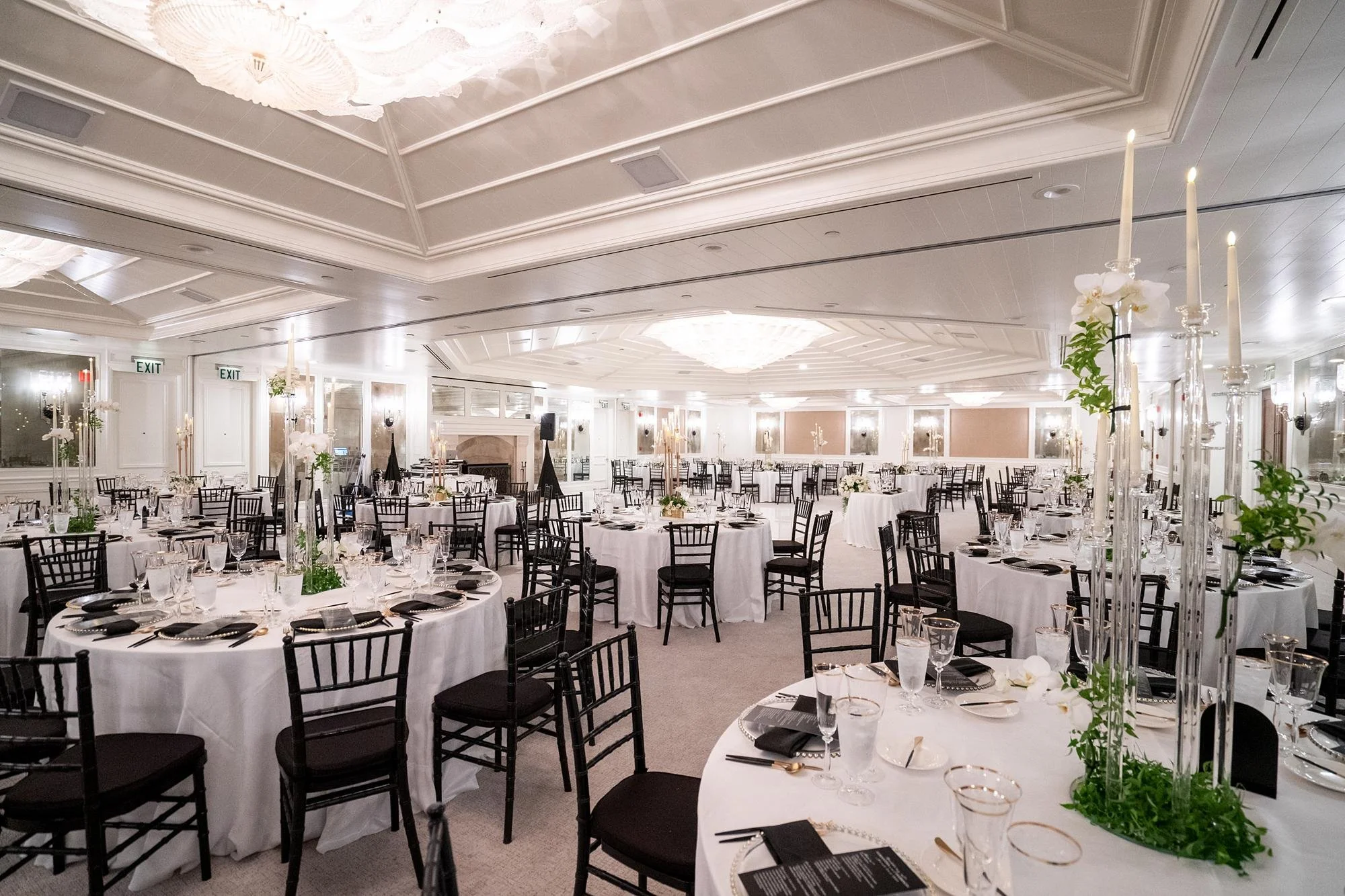 Wedding reception in the Grand Salon at Shutters on the Beach with black chairs and candles