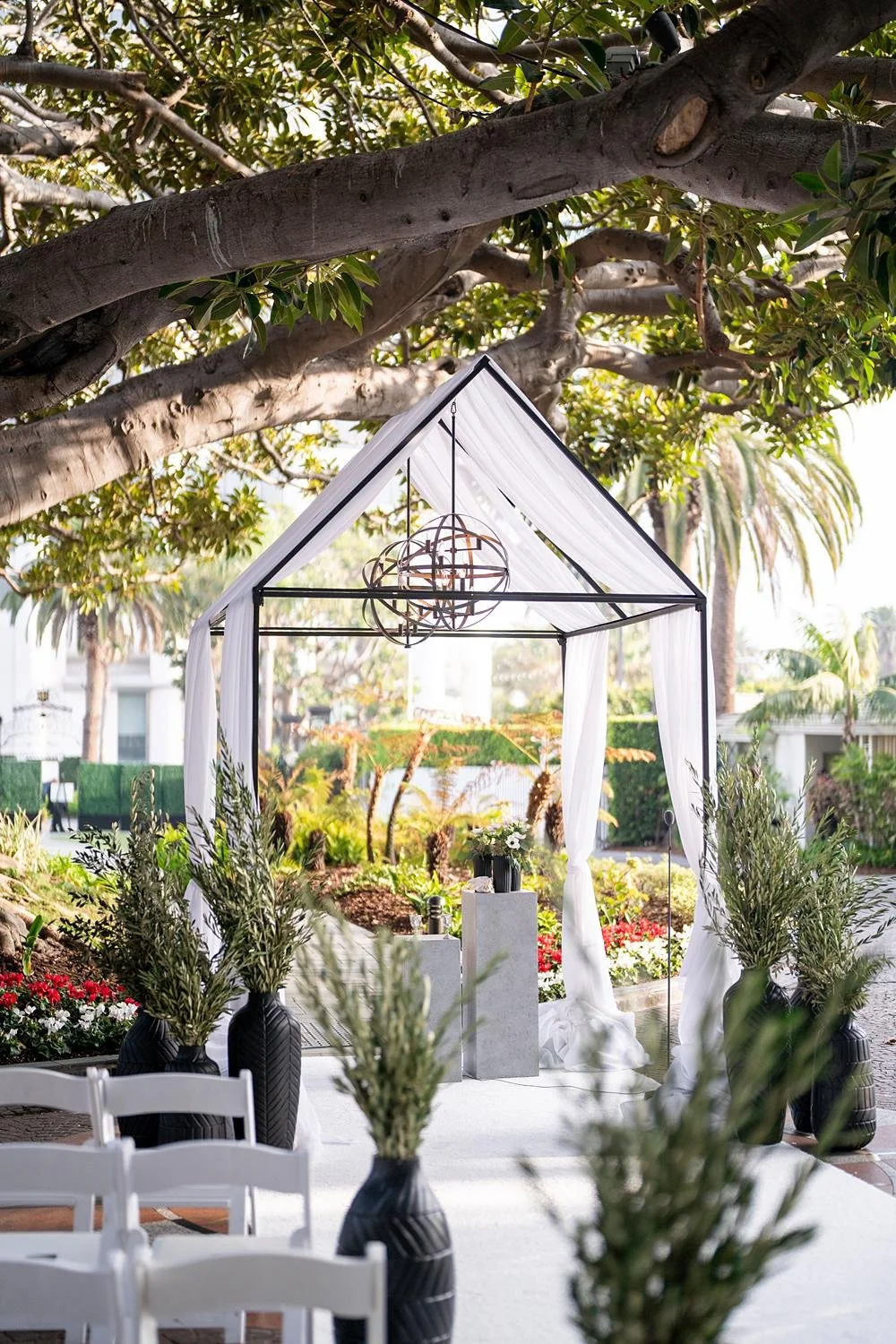 Modern Jewish chuppah with white drapery during Moreton Bay Circle wedding ceremony at Fairmont Miramar