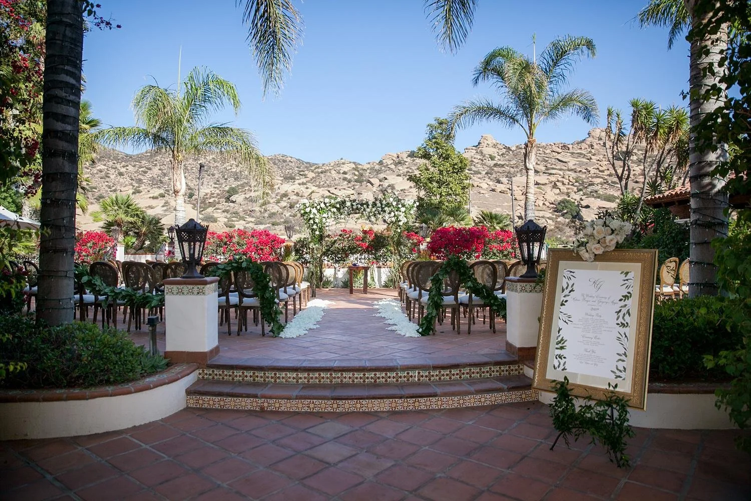 Wide view of a Villa wedding ceremony with mountains in the background at Hummingbird Nest Ranch