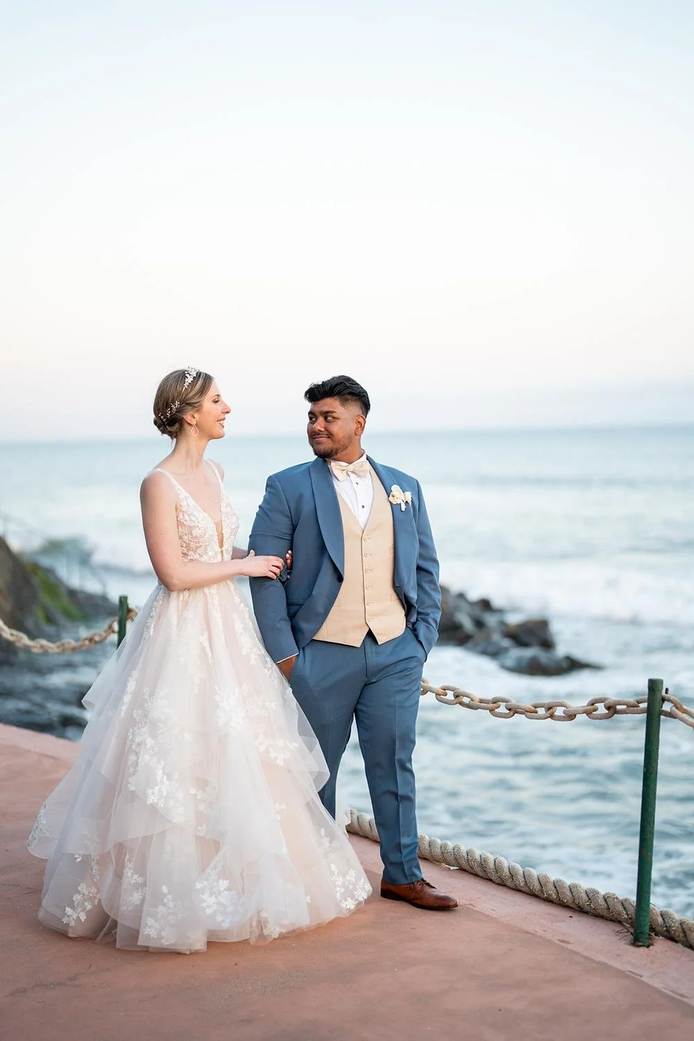 Wedding portraits of couple walking along an oceanfront path at Cypress Sea Cove