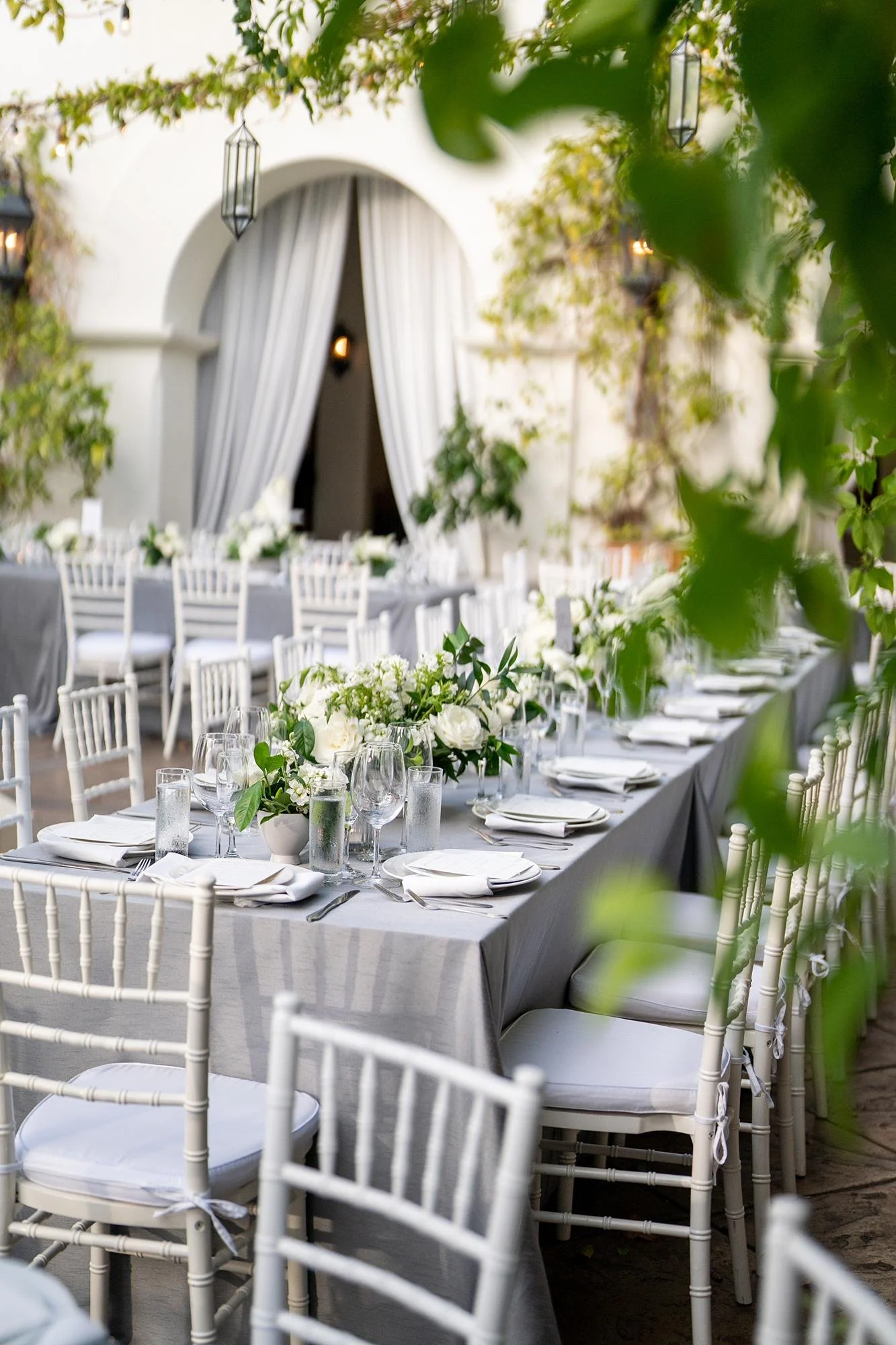 Wedding reception at Villa and Vine with long table styled with white floral centerpiece