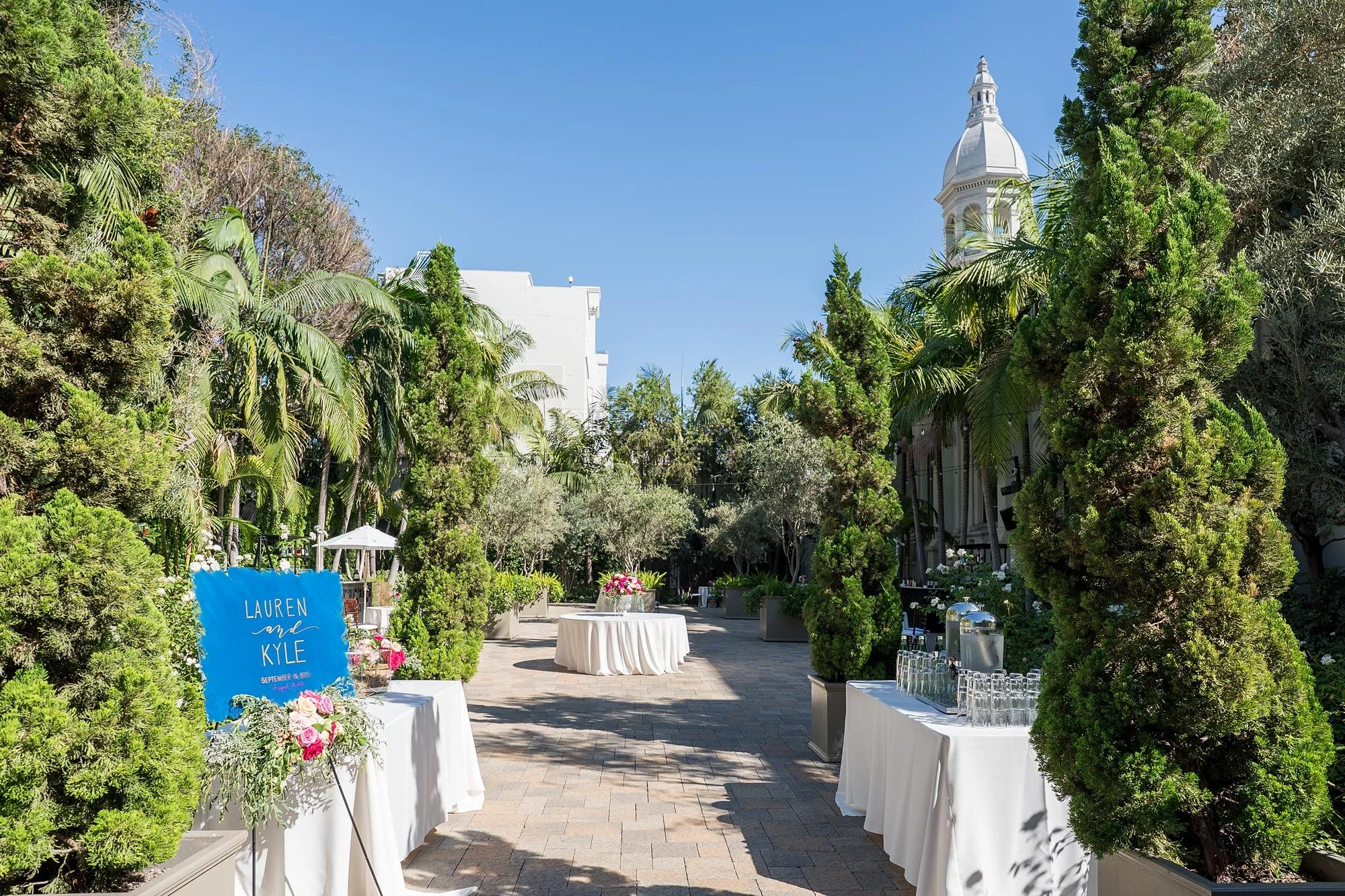 Courtyard cocktail décor highlighting the entrance and architecture during a wedding at Vibiana in Los Angeles