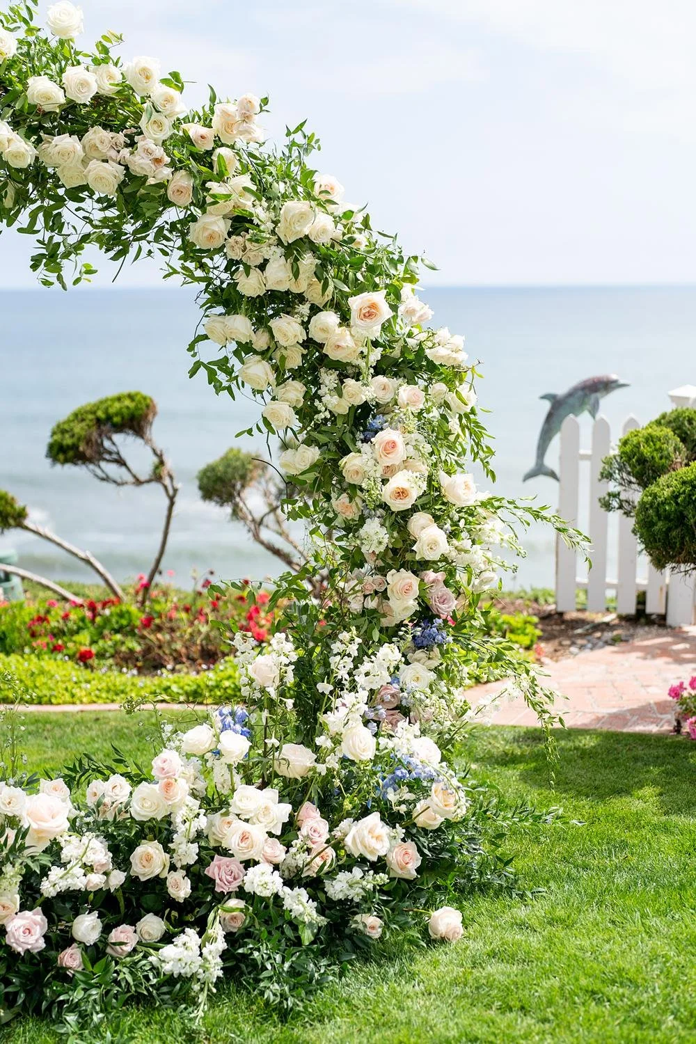 Wedding ceremony detail of a circular rose arch at Cypress Sea Cove