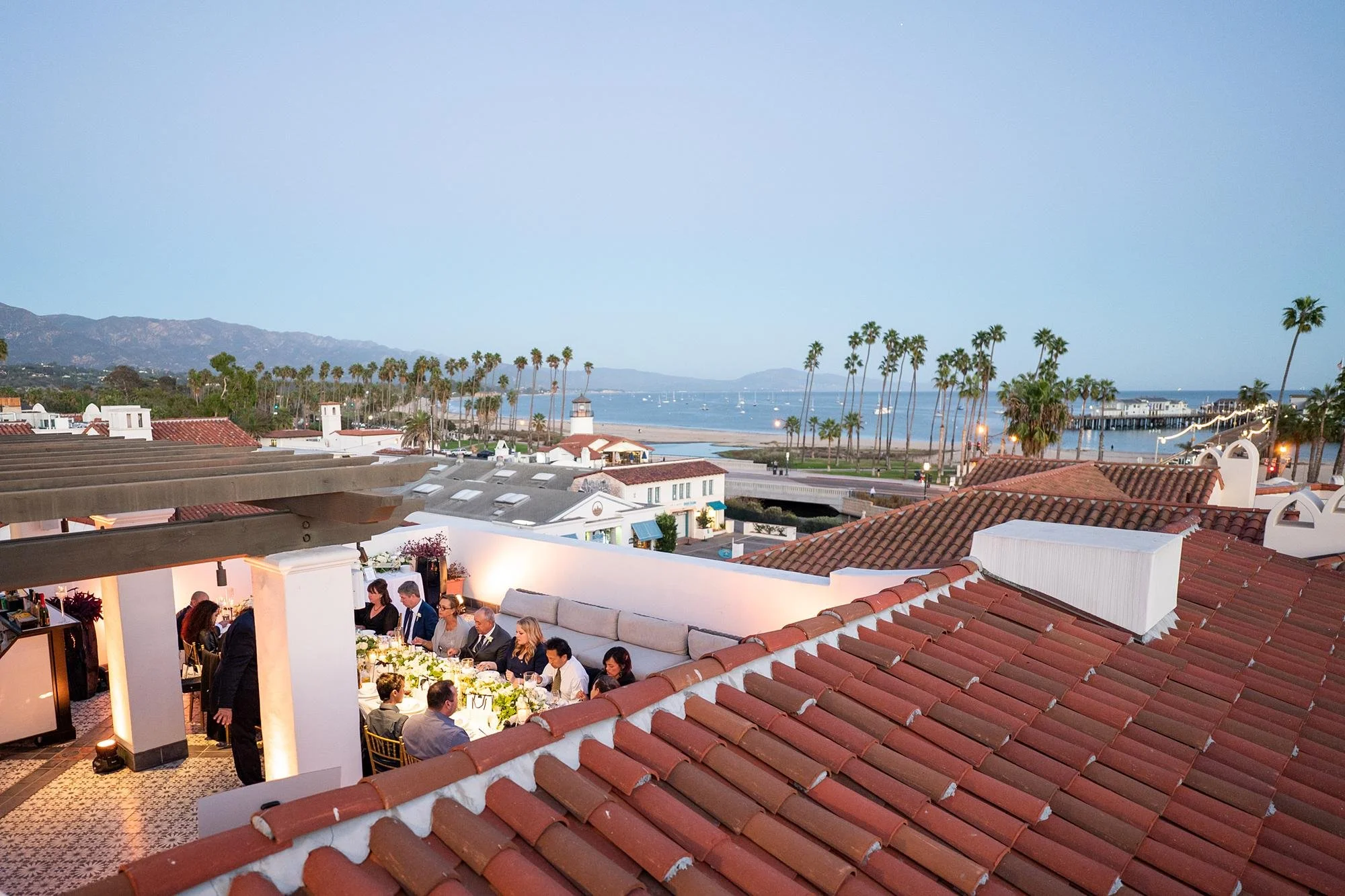 Wedding reception at Hotel Californian with guests dining at sunset overlooking Santa Barbara coastline