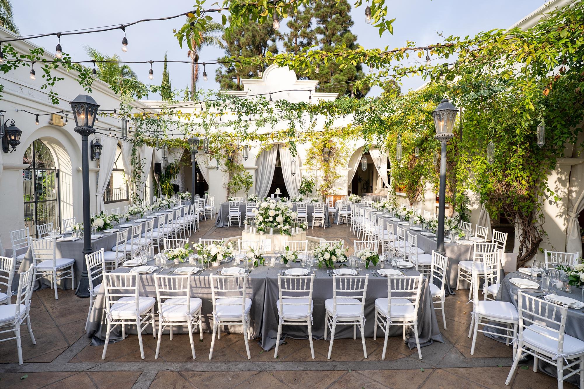 Wedding reception at Villa and Vine with courtyard filled with white rose florals