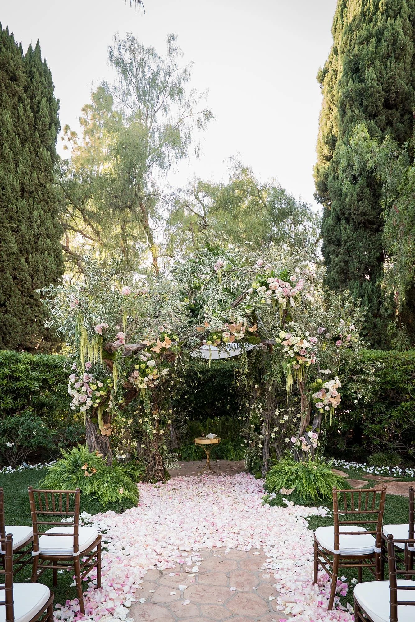 Wedding ceremony detail of a chuppah with olive branches and cascading roses at the Beverly Hills Hotel