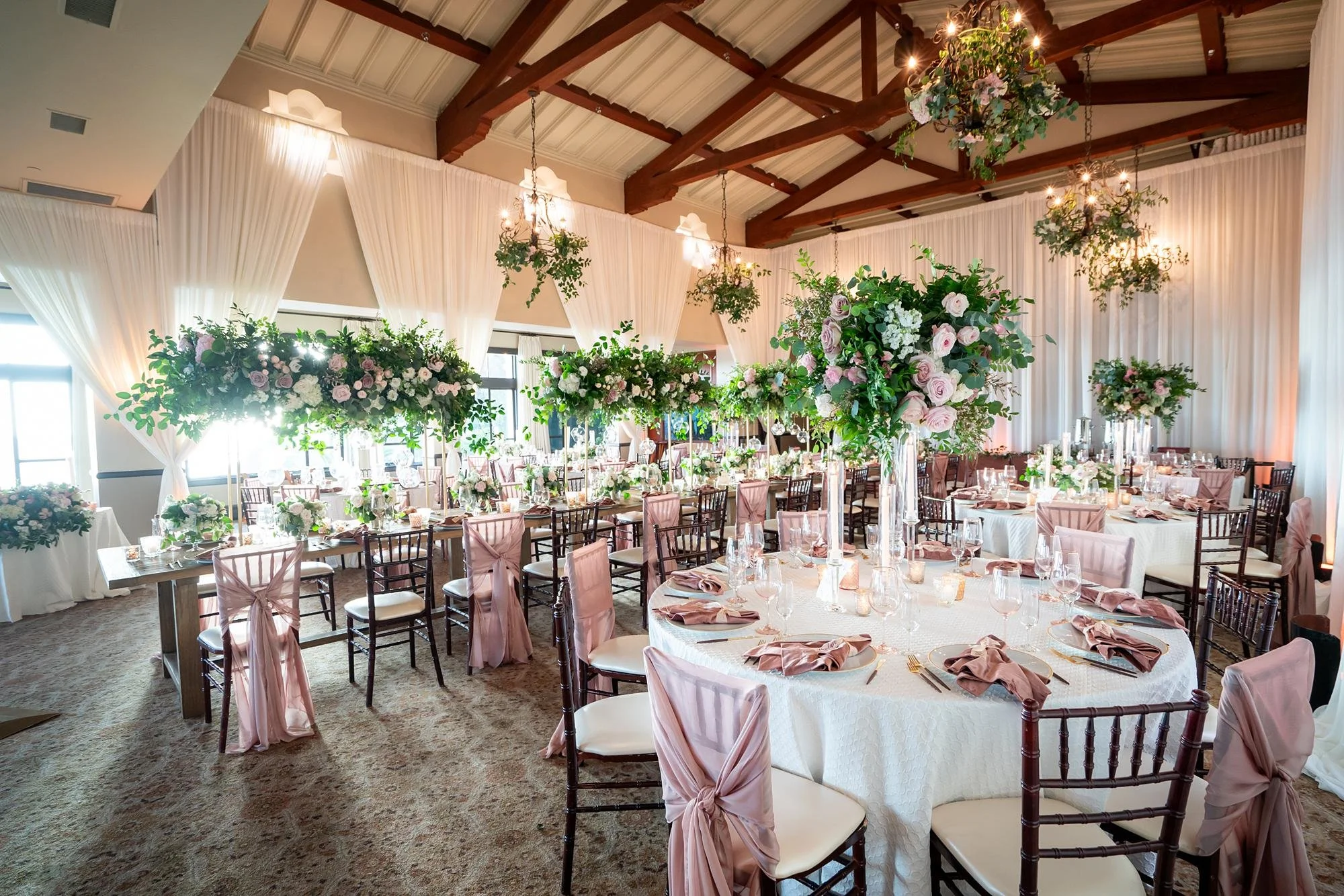 Dining Room wedding reception decorated with pink and white florals at Bel Air Bay Club