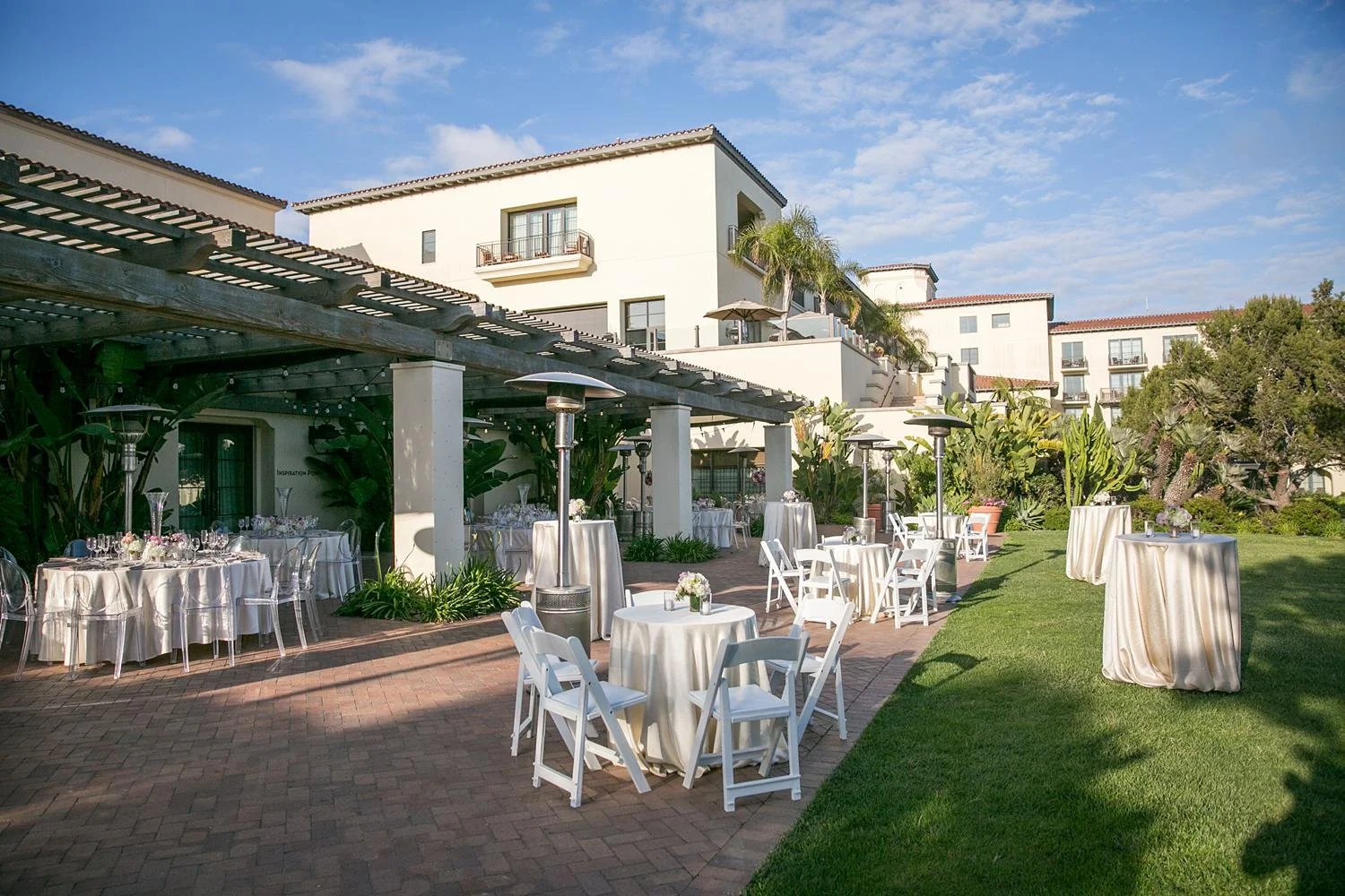 Wide view of Point Terrace Lawn wedding reception with dinner and cocktail tables at Terranea Resort