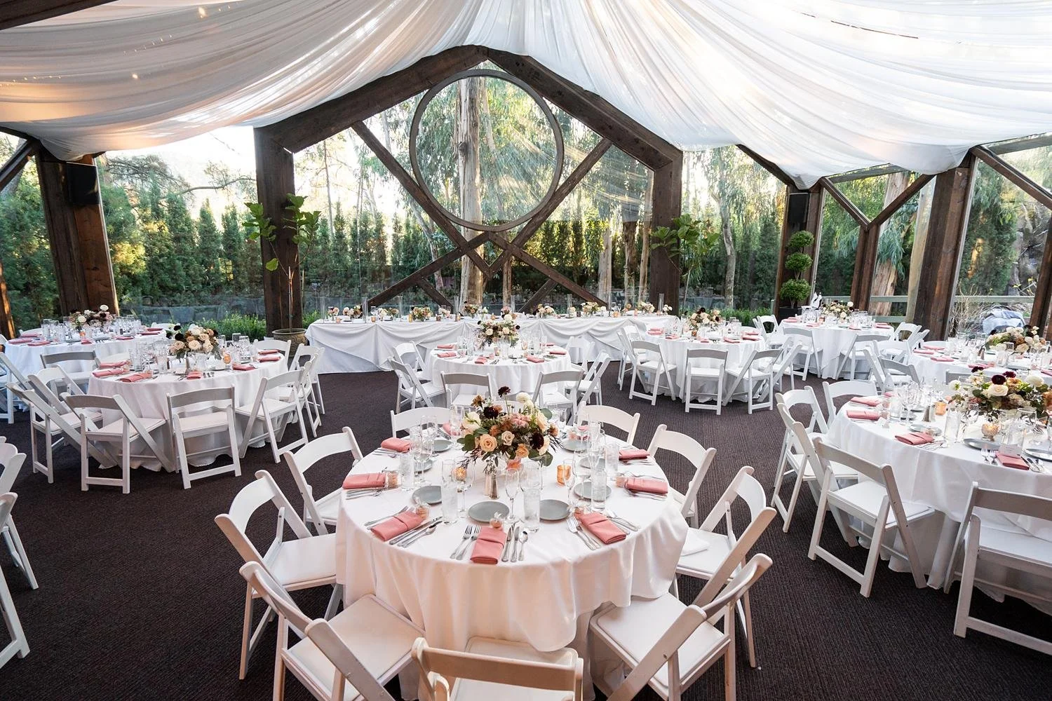 Wedding reception at Calamigos Ranch Oak Room featuring white and pink themed decor