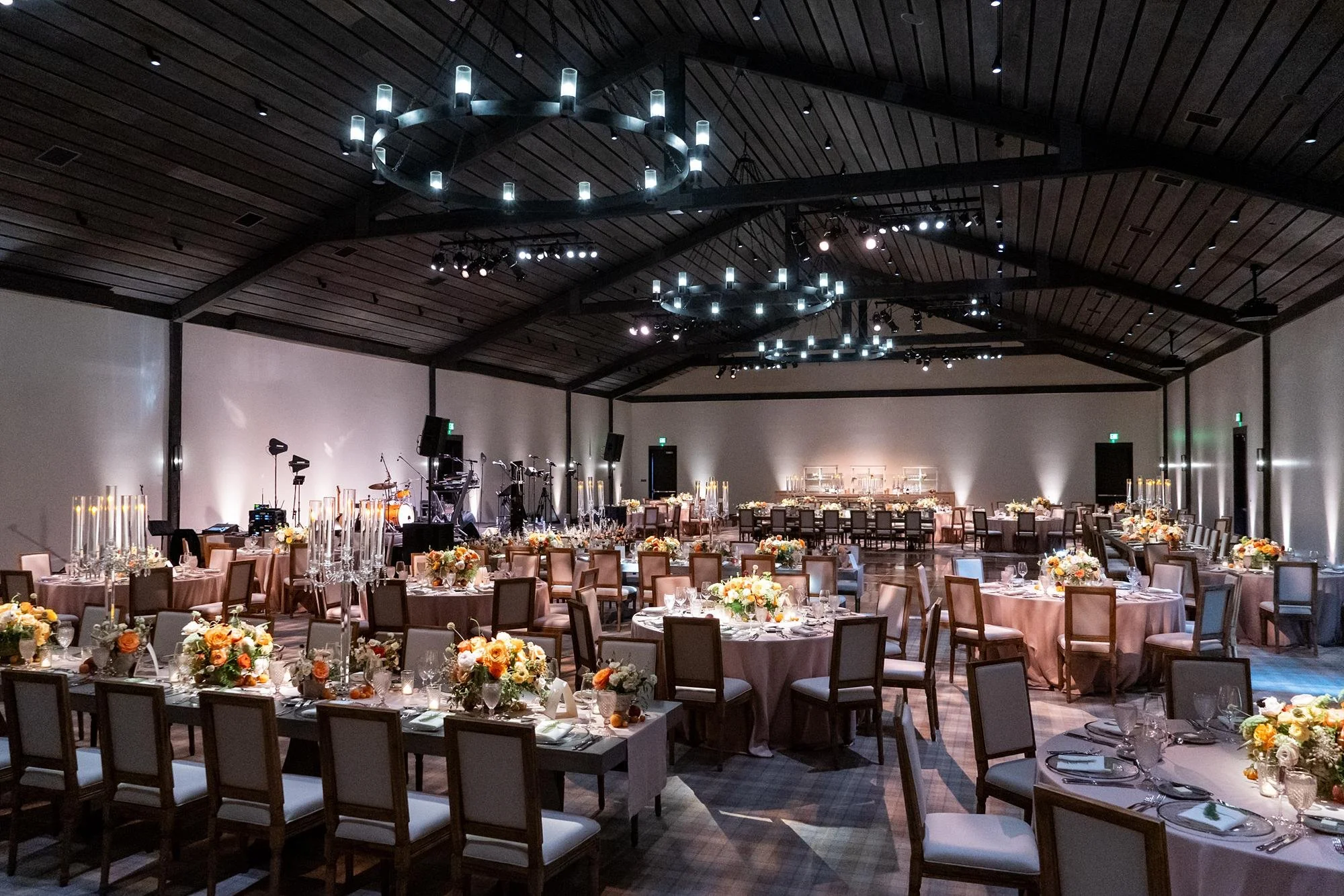 Wedding reception at the Farmhouse at Ojai Valley Inn and Spa with orange florals and candelabras