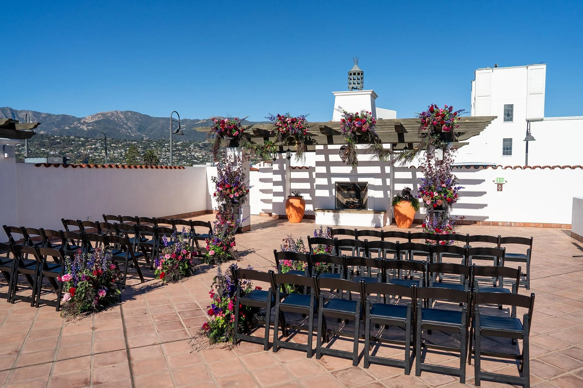 Wedding ceremony at Hotel Californian on Serena Rooftop with mountains in the background