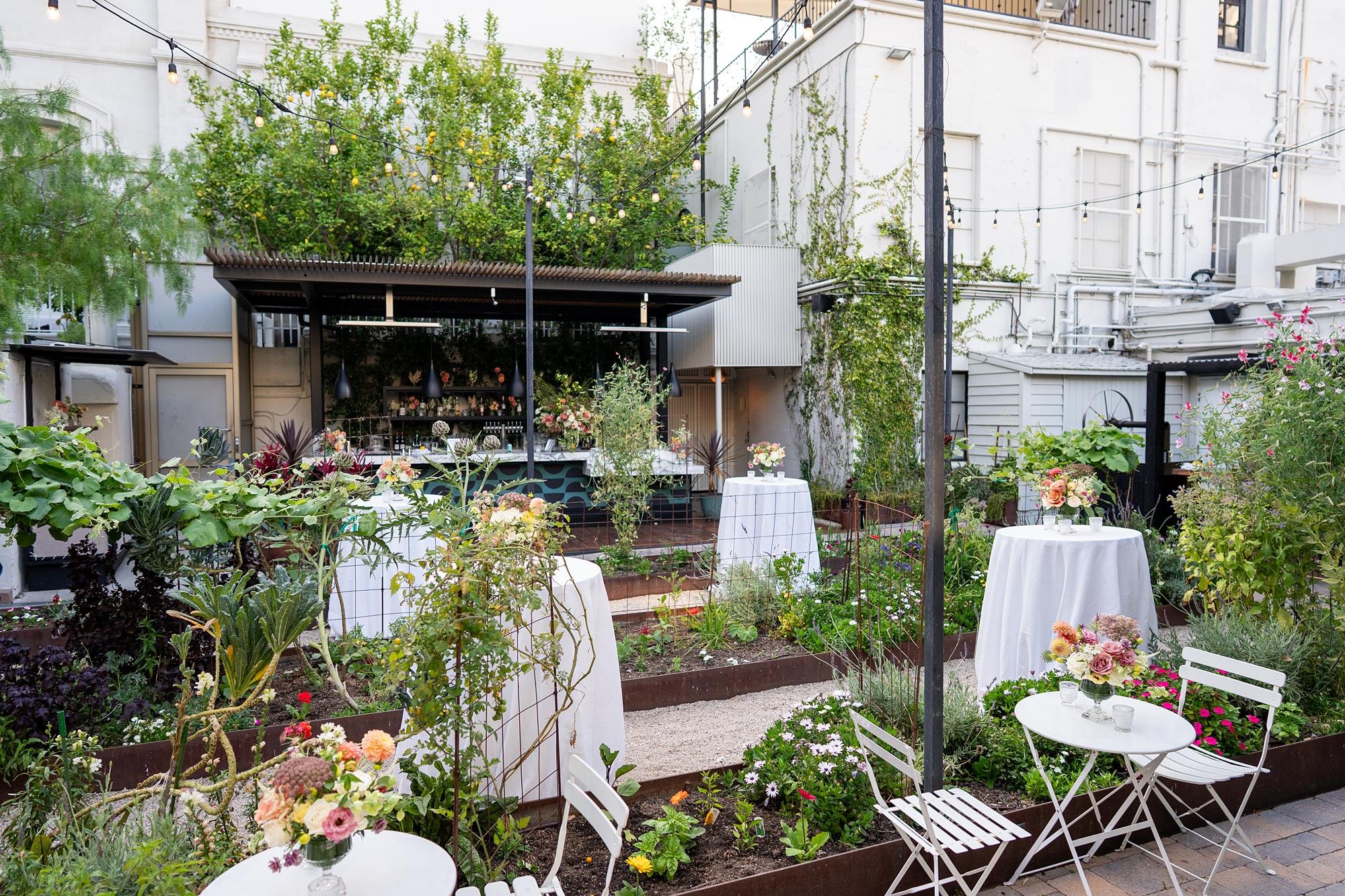 Wide view of wedding cocktail hour in Redbird Garden at Vibiana in Los Angeles