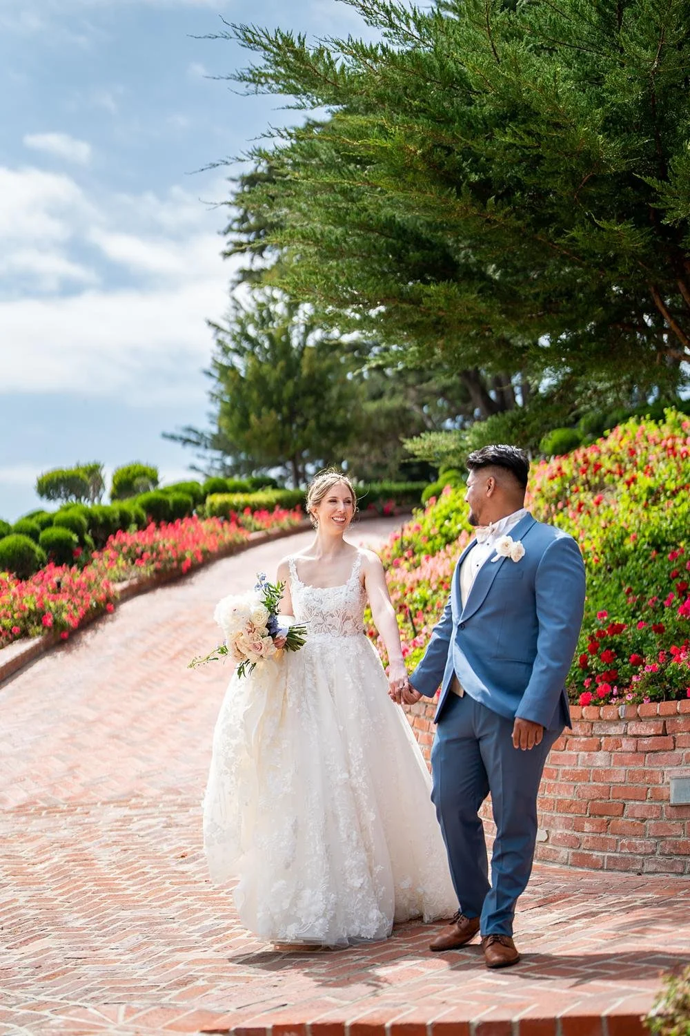 Wedding portraits of couple walking along a brick path at Cypress Sea Cove