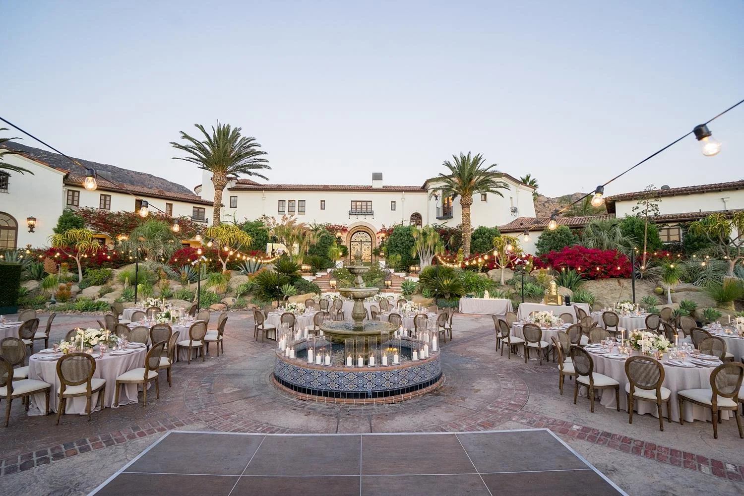 Guests enjoying a wedding reception at the Villa during sunset at Hummingbird Nest Ranch