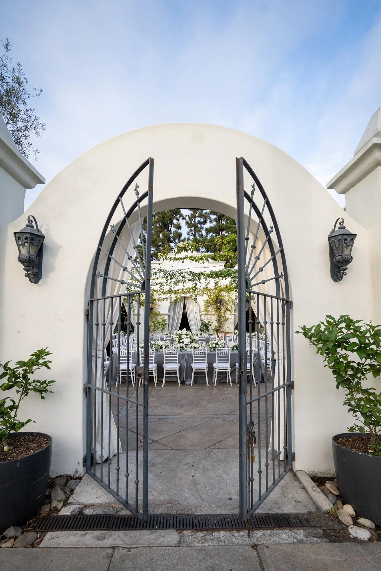 Wedding at Villa and Vine featuring iron gate opening into courtyard