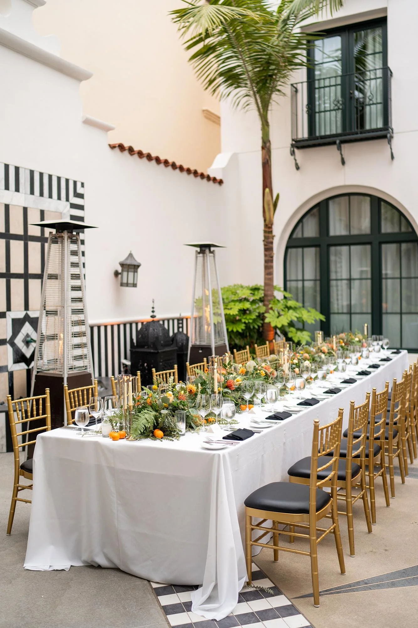 Wedding reception at Hotel Californian Court of Fatima with long table and tropical florals