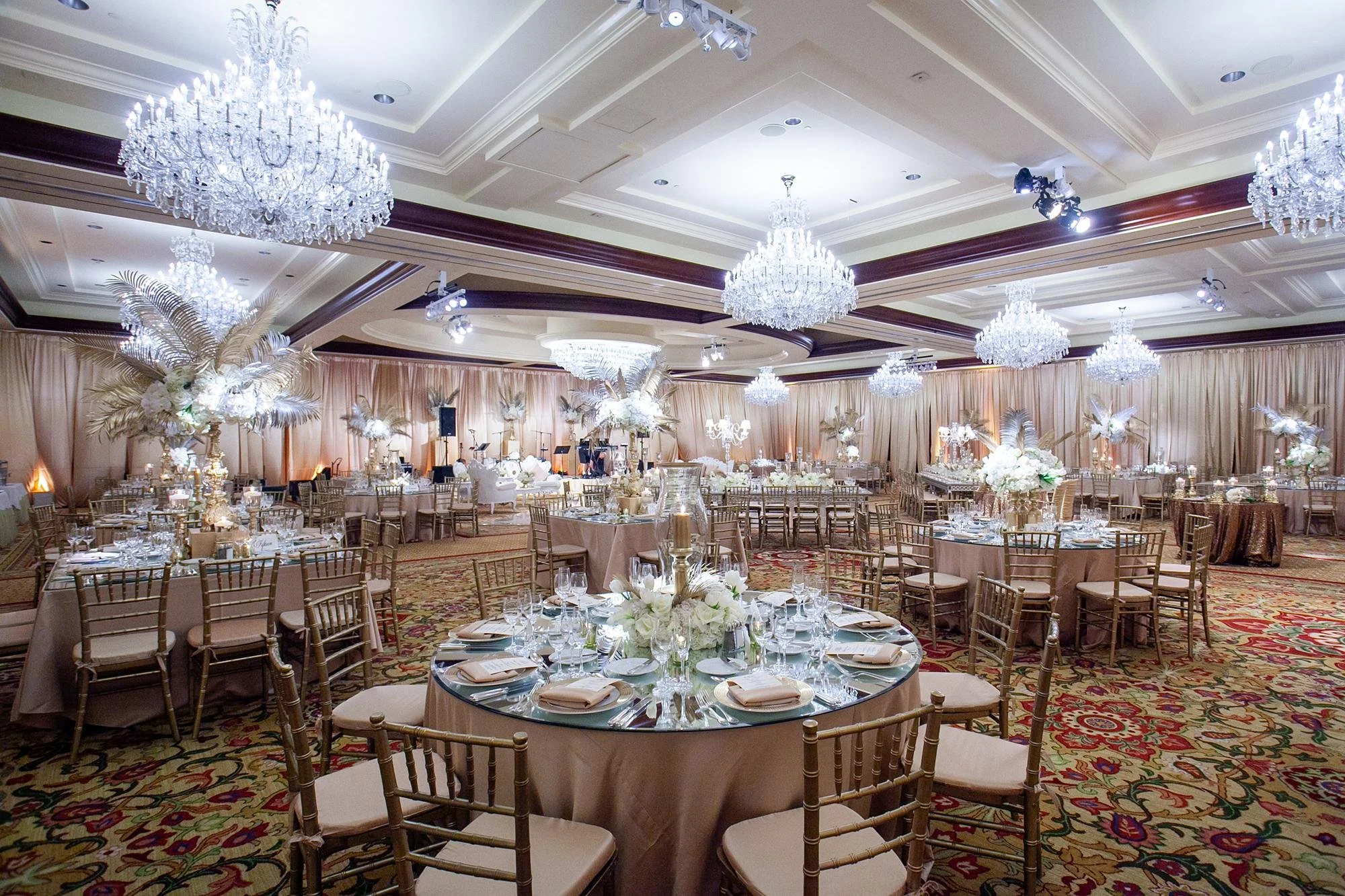 Wedding reception in the Grand Ballroom at Four Seasons Westlake with tall and low centerpieces