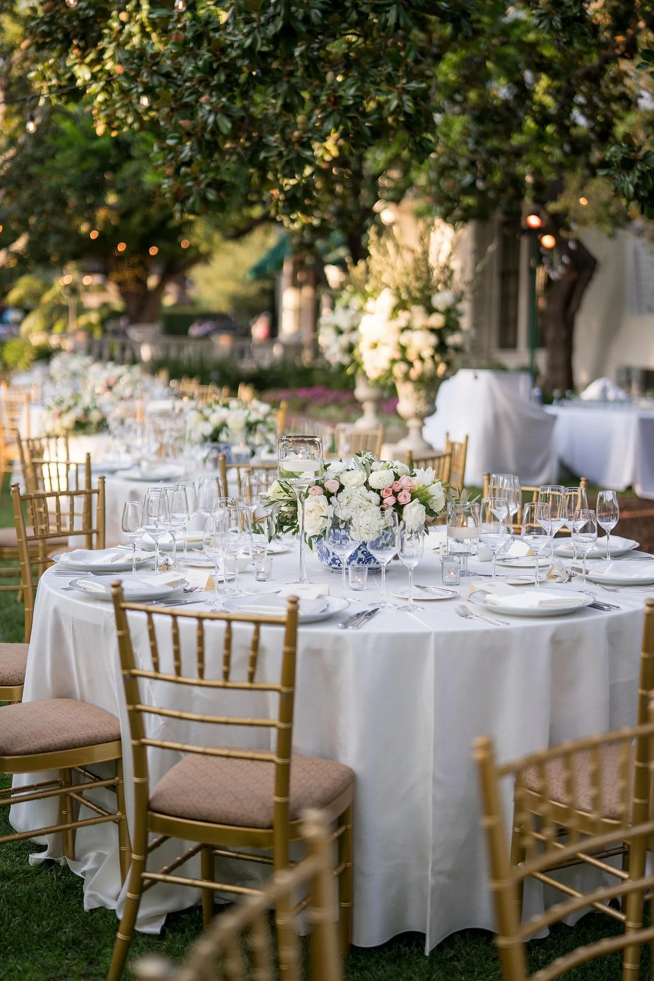 Wedding reception table styled with white and pink florals on the Front Lawn at the Valley Hunt Club