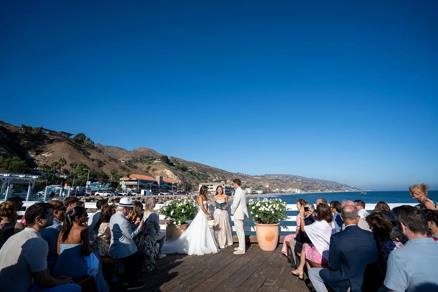Wedding ceremony at Malibu Farm at the Pier with bride and groom exchanging vows