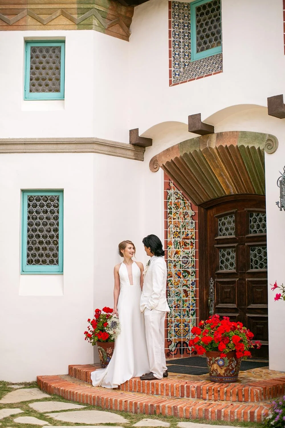 Wedding portraits at Adamson House of bride and groom on the front steps