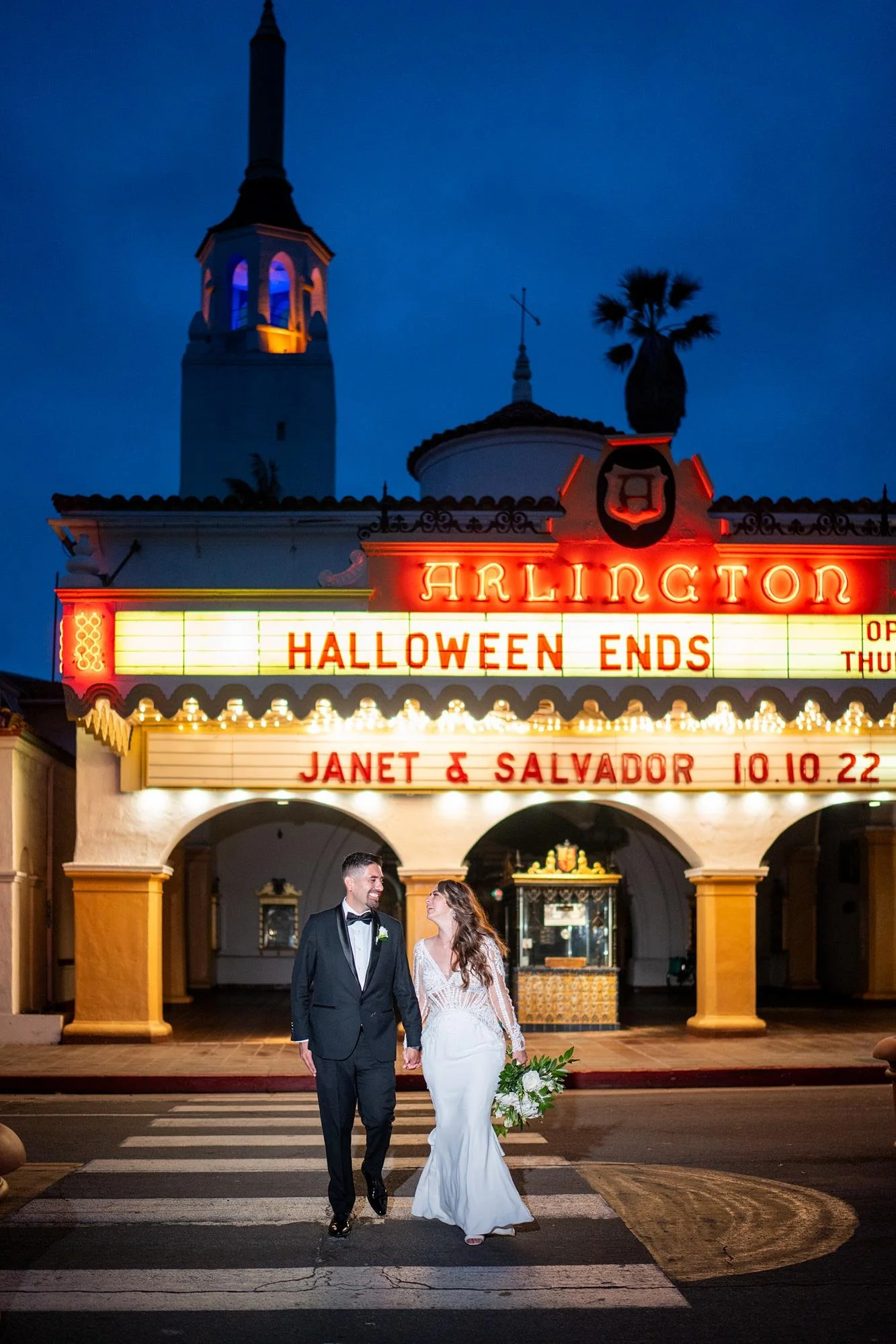 Wedding portraits at Villa and Vine with couple crossing street beneath marquee