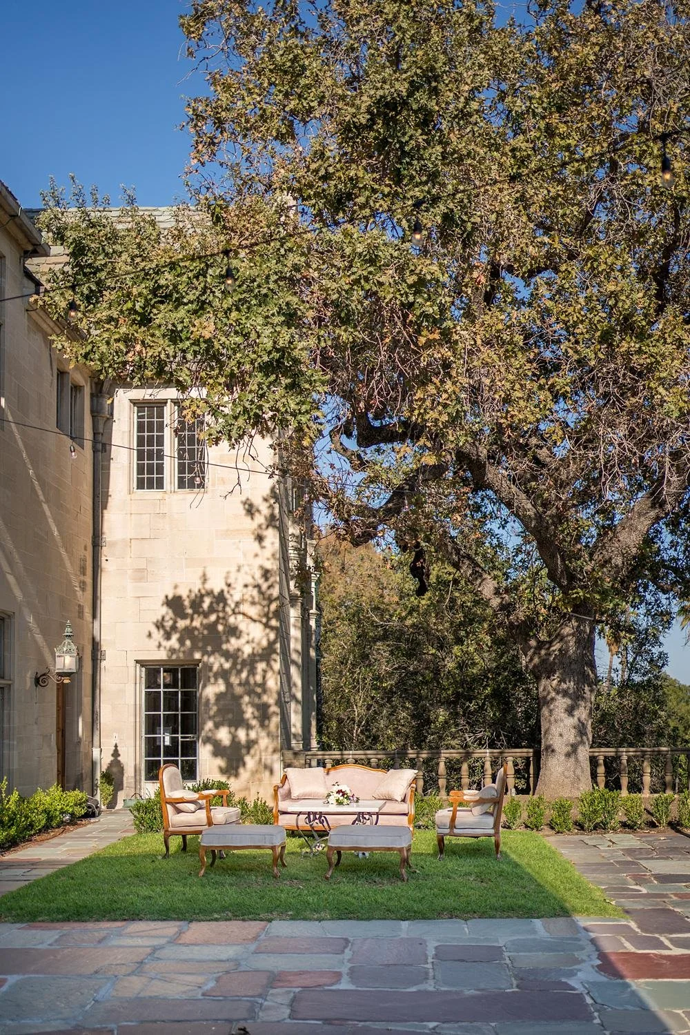 Wedding cocktail lounge seating with sofa and chairs arranged near the Reflection Pond at Greystone Mansion