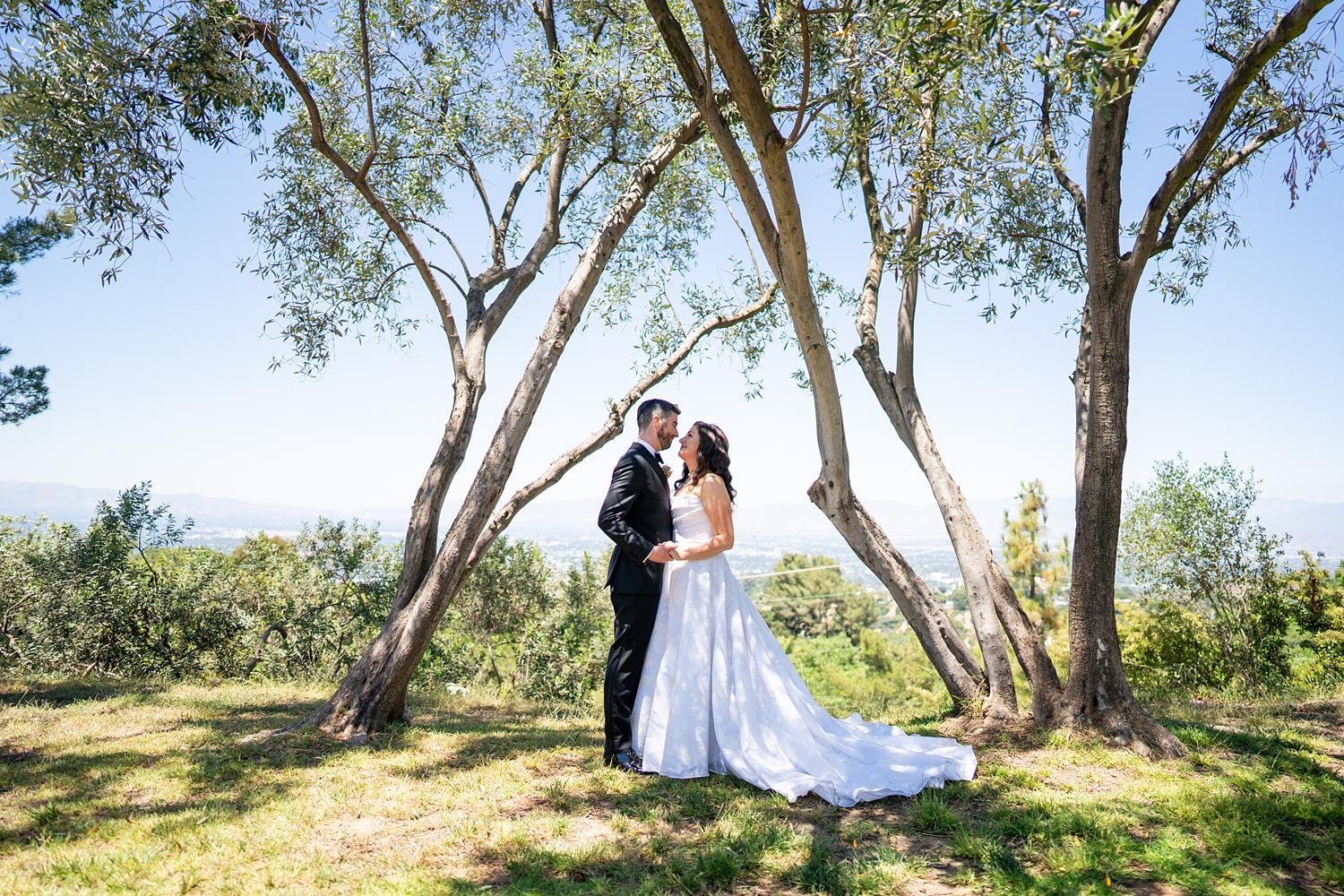 Wedding portraits of bride and groom with valley view at Stephen Wise Temple
