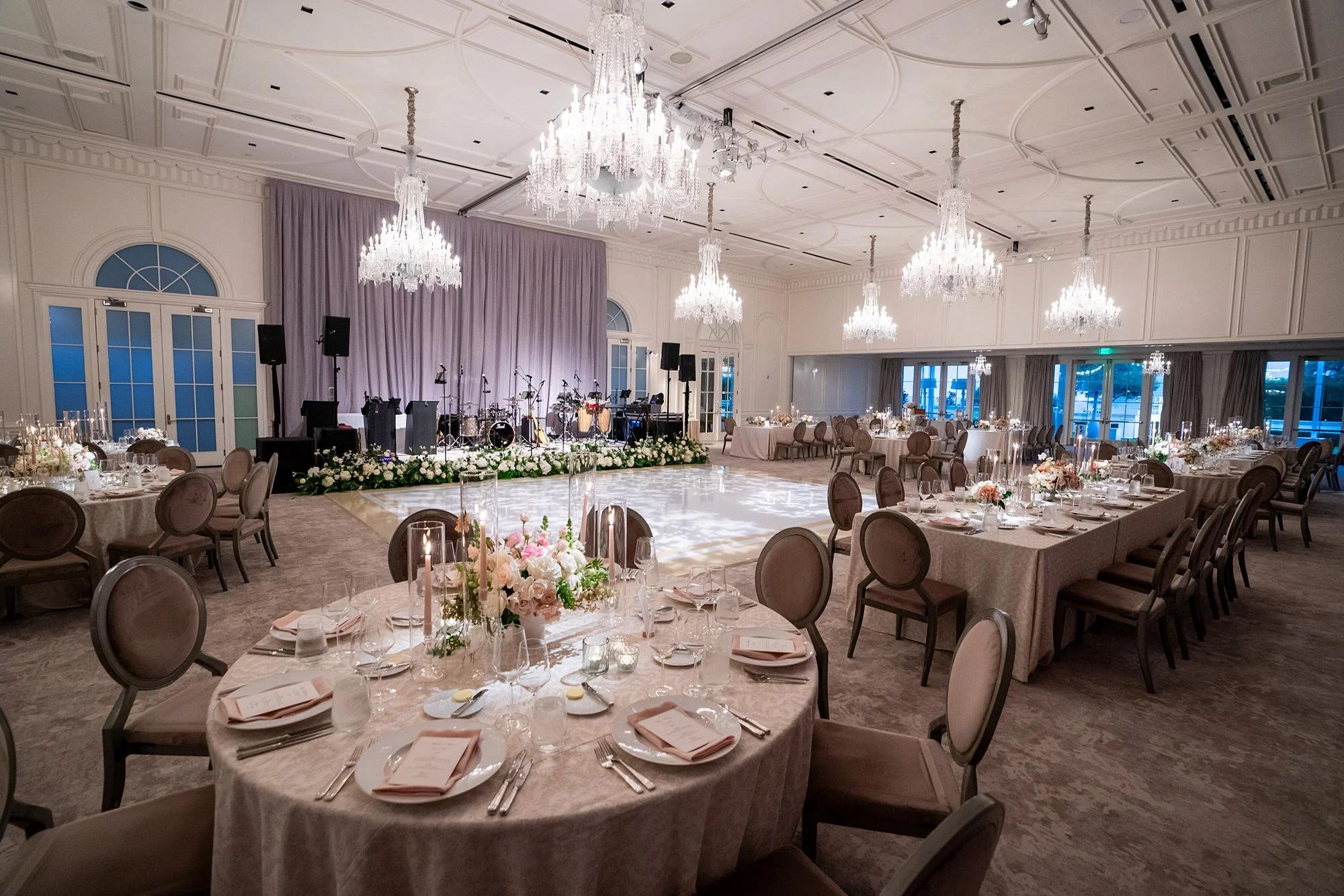 Wide view of the band stage and dance floor during a wedding reception at Rosewood Miramar Beach