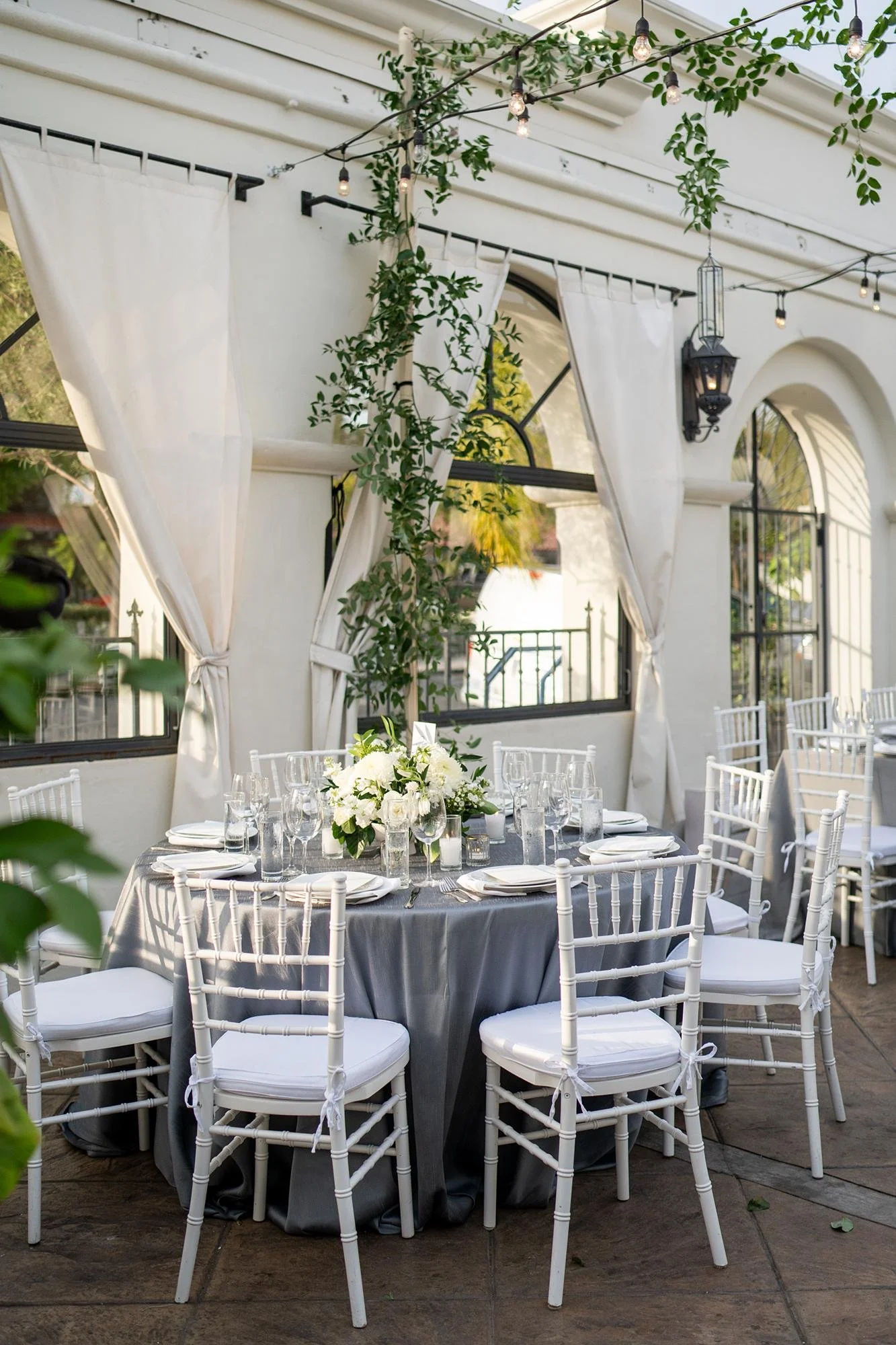 Wedding reception at Villa and Vine with round table and white rose centerpiece