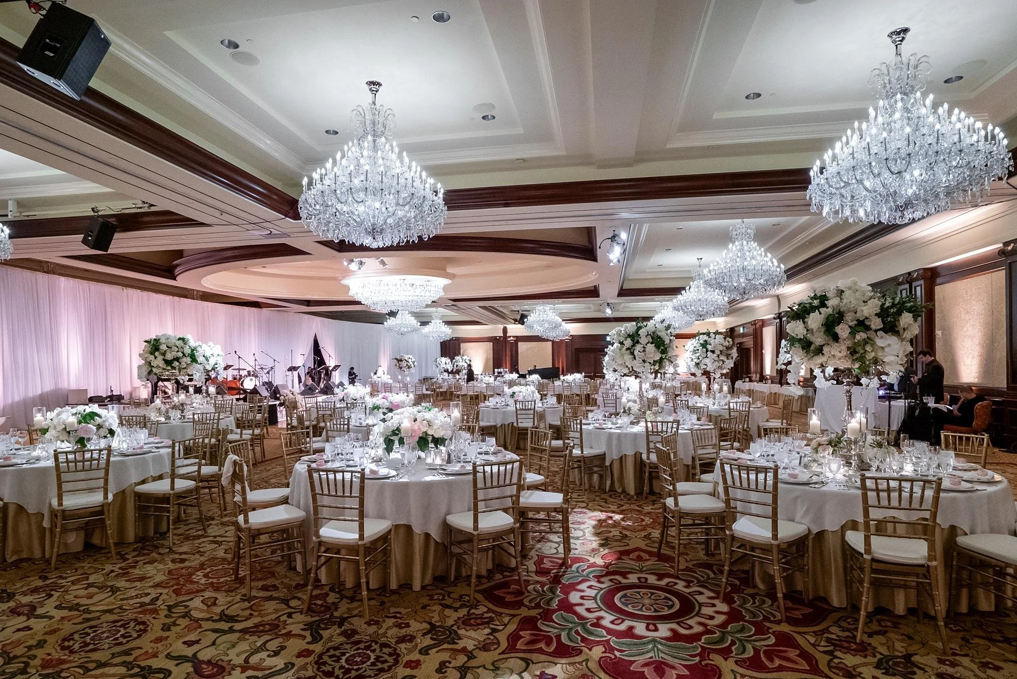 Wedding reception at the Four Seasons Westlake featuring rose centerpieces in the Grand Ballroom