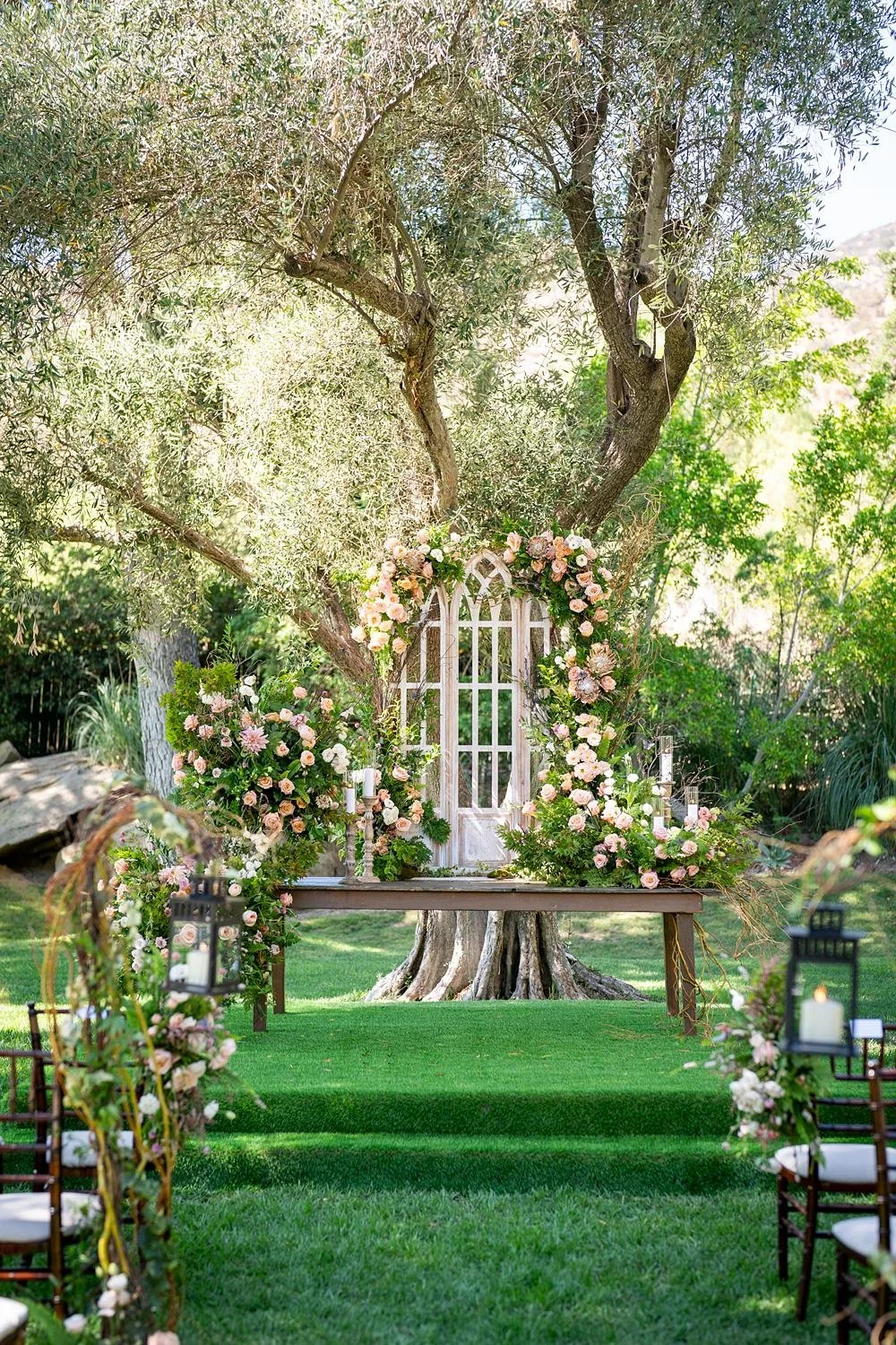 Close-up of the wedding altar with cascading roses and candles on the Sitting Bull lawn at Hummingbird Nest Ranch