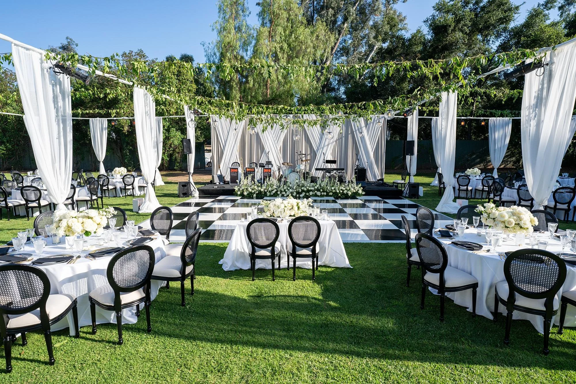 Wedding reception on the Orchard Lawn at Ojai Valley Inn and Spa with drapery and checkerboard dance floor