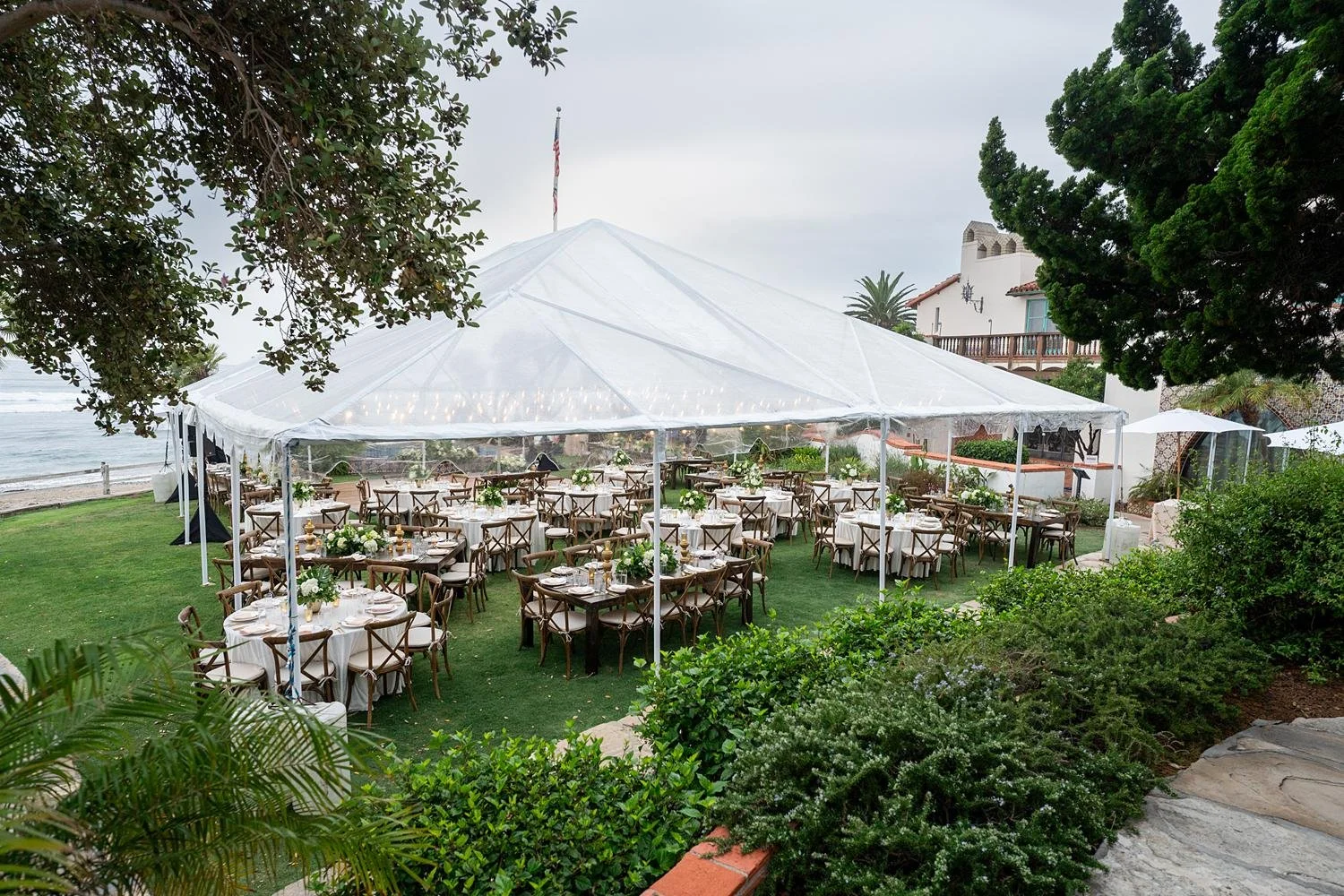 Wedding reception at Adamson House on the Back Lawn beneath a tinted evening tent
