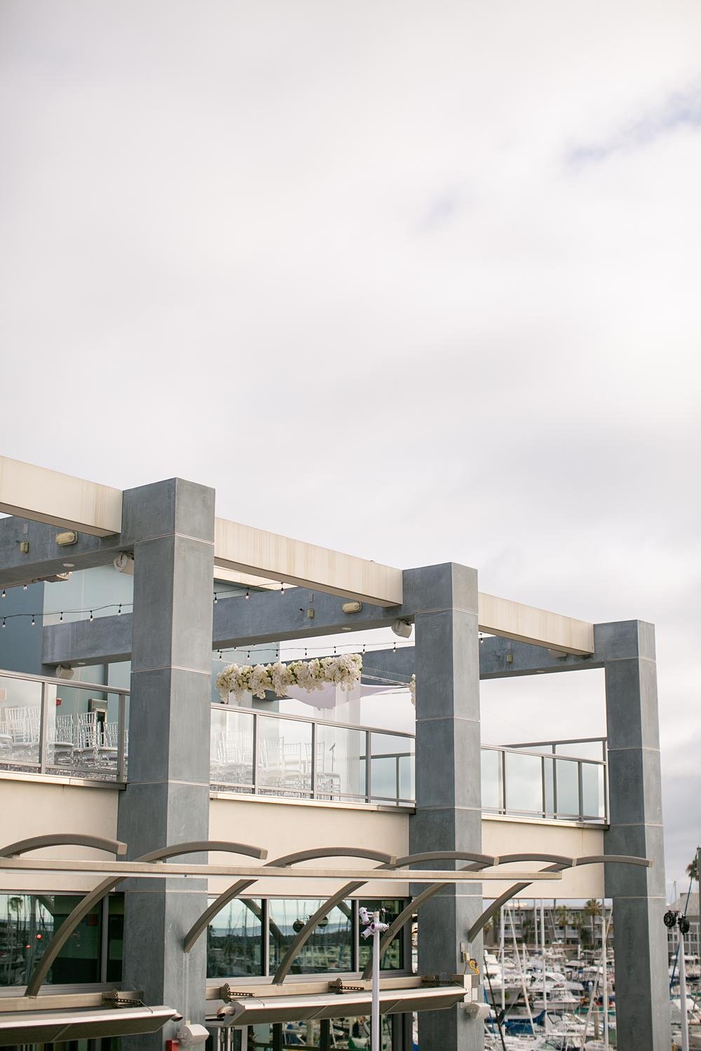 Wedding ceremony at Shade Hotel Redondo Beach on the Sky Level viewed from across the courtyard with ceremony visible
