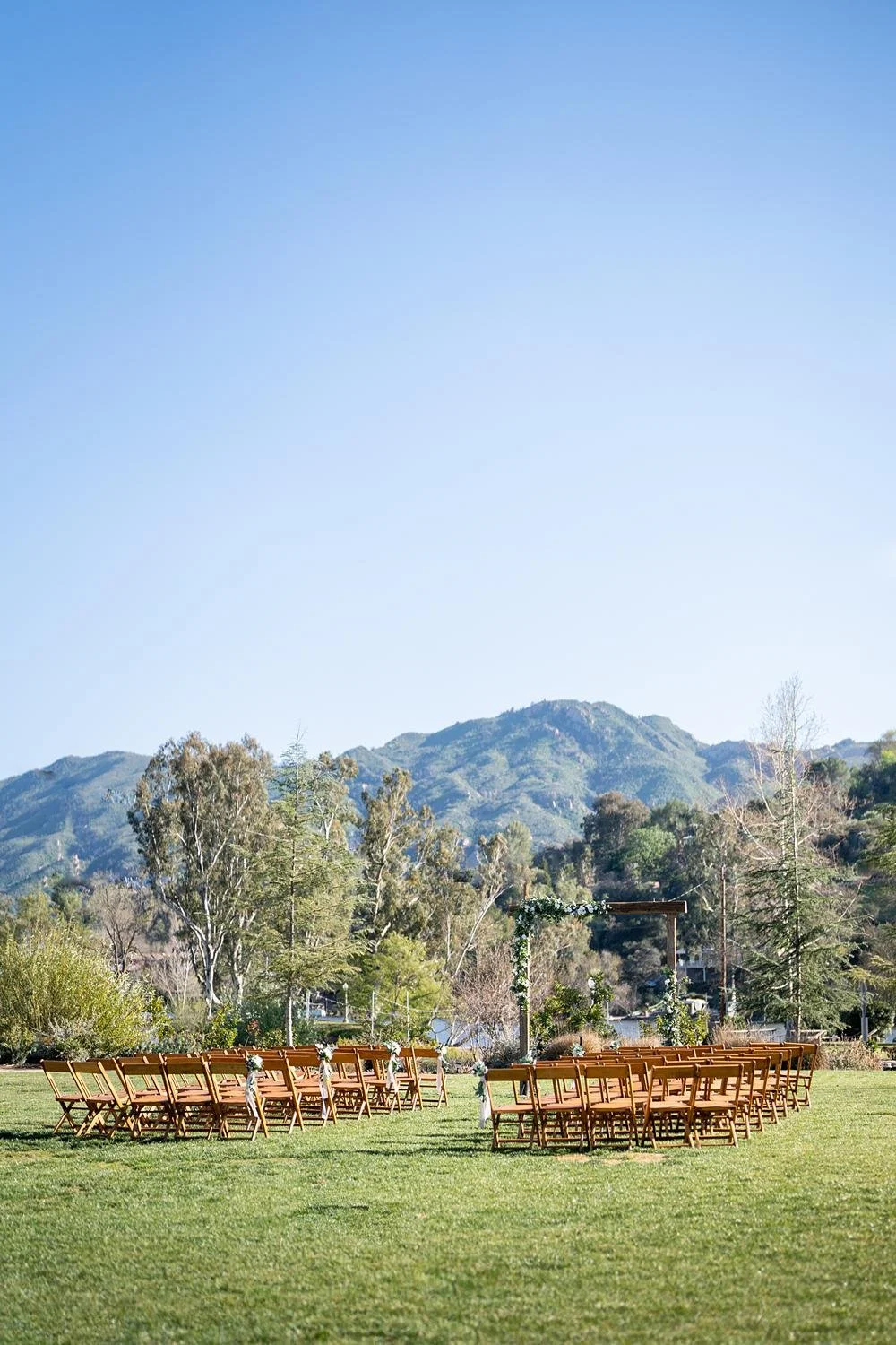 Wedding ceremony on the lawn at the Lodge at Malibou Lake with the lake view