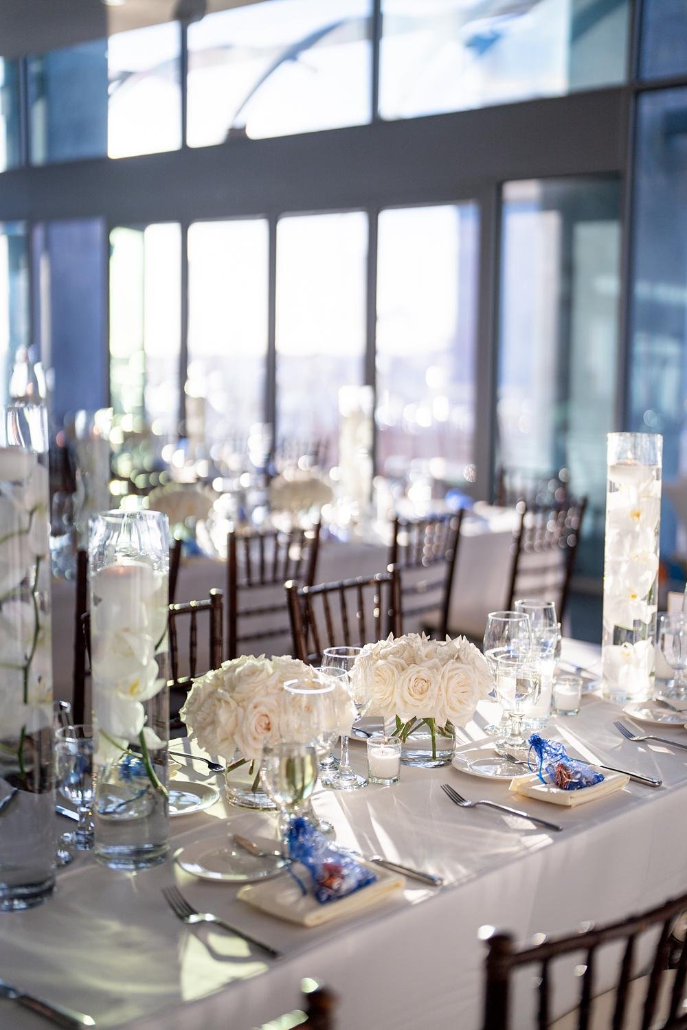 Horizon Level wedding reception at Shade Hotel Redondo Beach with rose centerpieces illuminated by window light