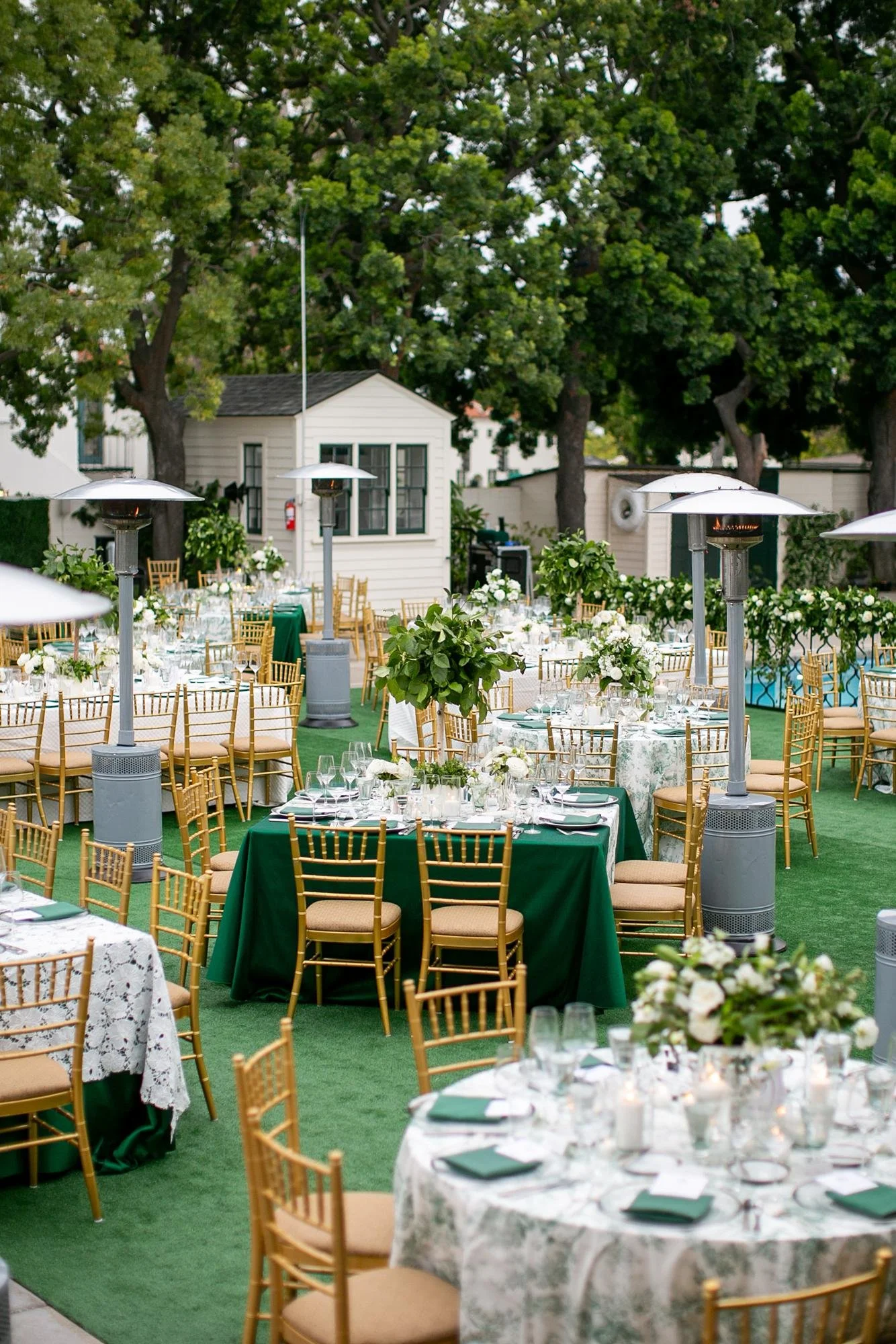 Wedding reception table featuring a tree centerpiece on the Back Lawn at the Valley Hunt Club