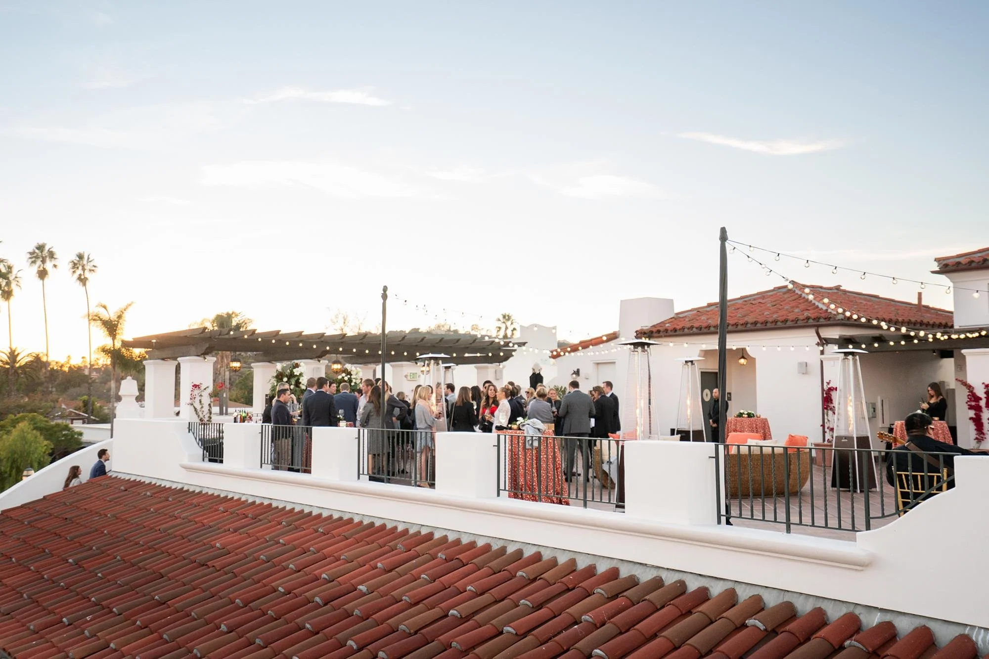 Wedding cocktails at Hotel Californian on Serena Rooftop with guests at sunset