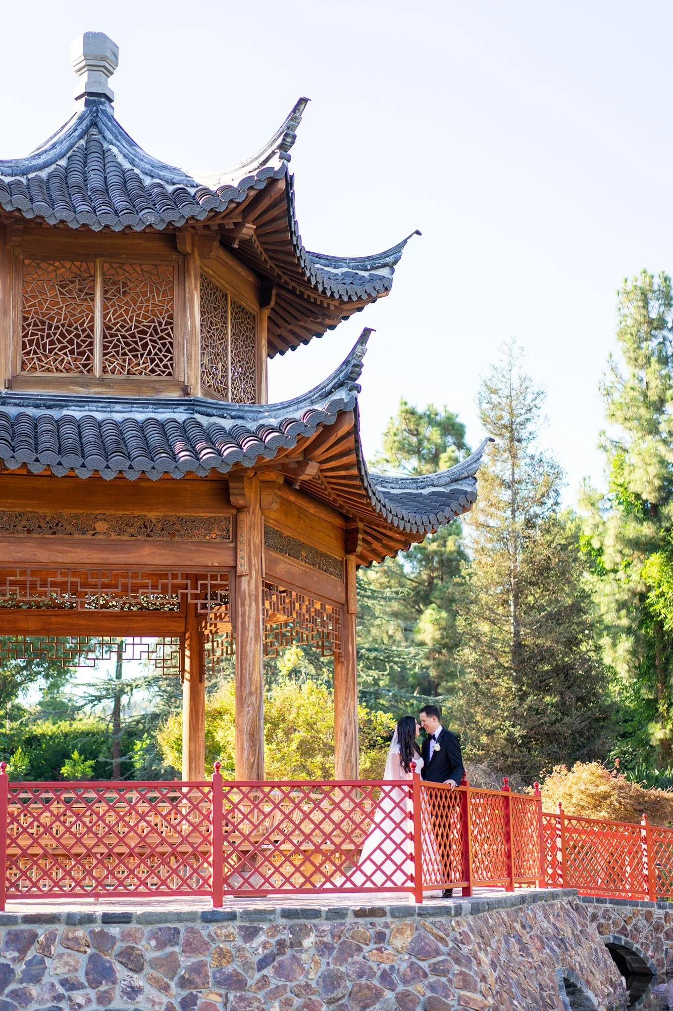 Wedding portrait at the Four Seasons Westlake of bride and groom beneath the Chinese Pagoda