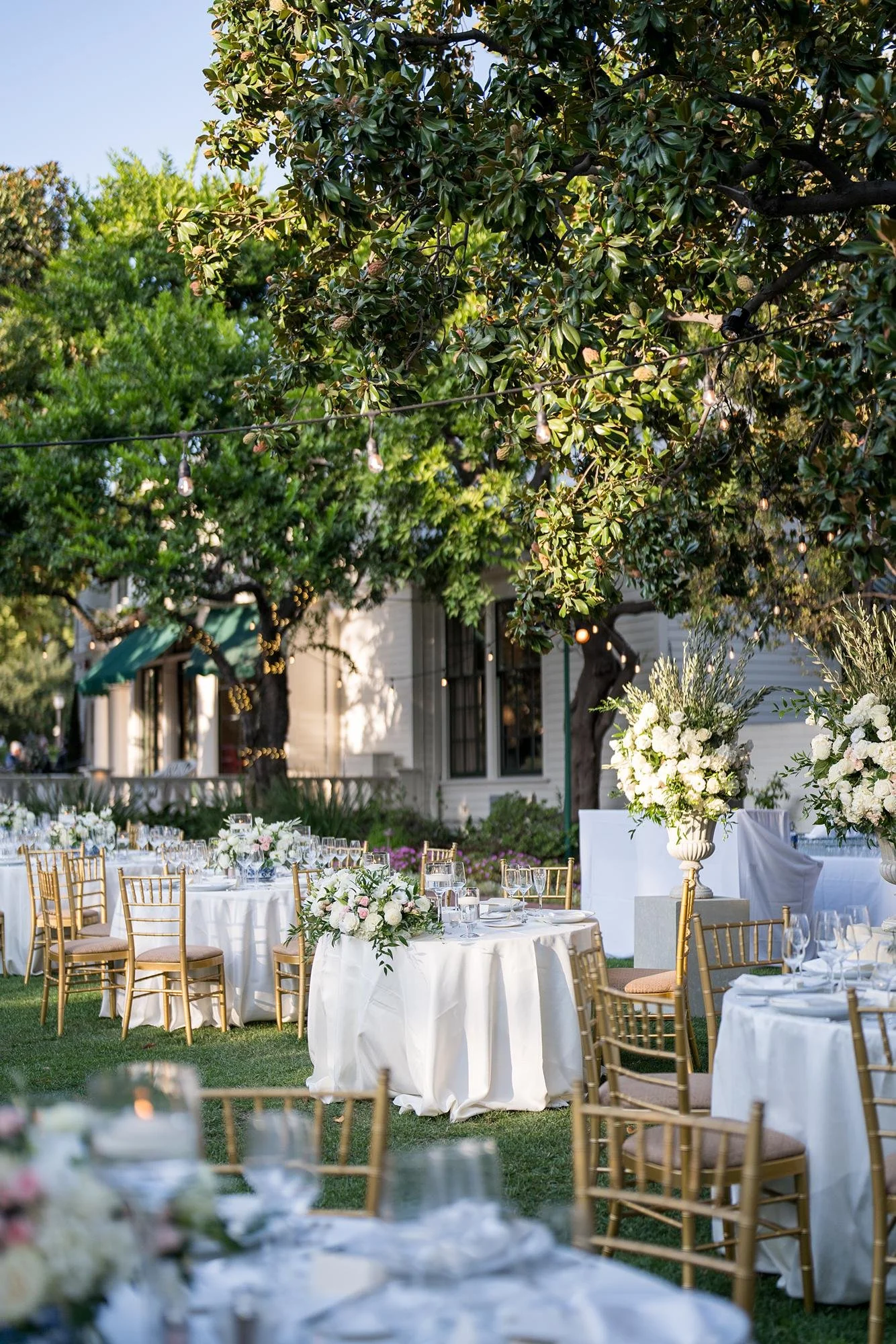 Wedding reception sweetheart table on the Front Lawn with white florals at the Valley Hunt Club