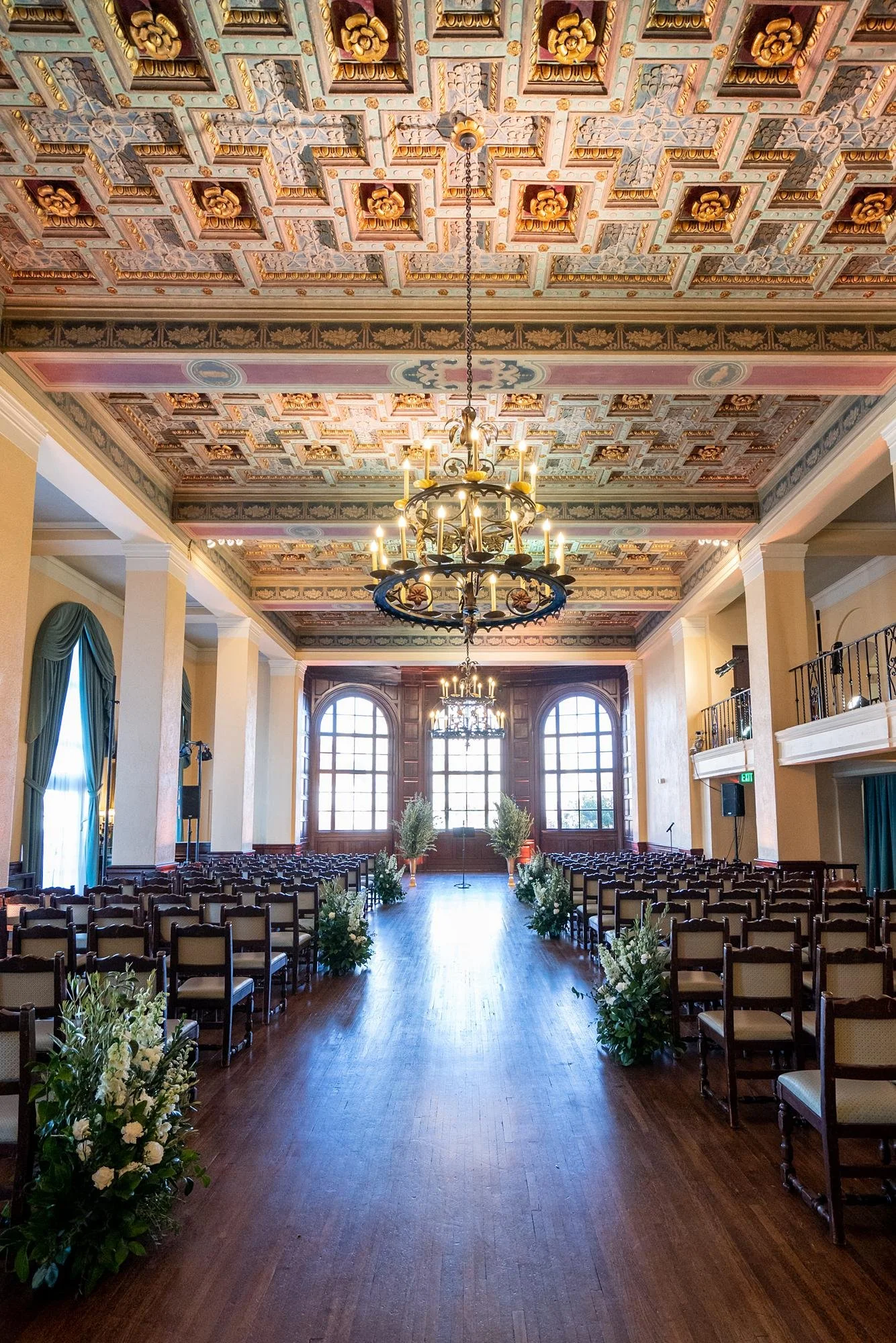 Wedding ceremony in Lounge with ornate ceiling lighting at Ebell of Los Angeles