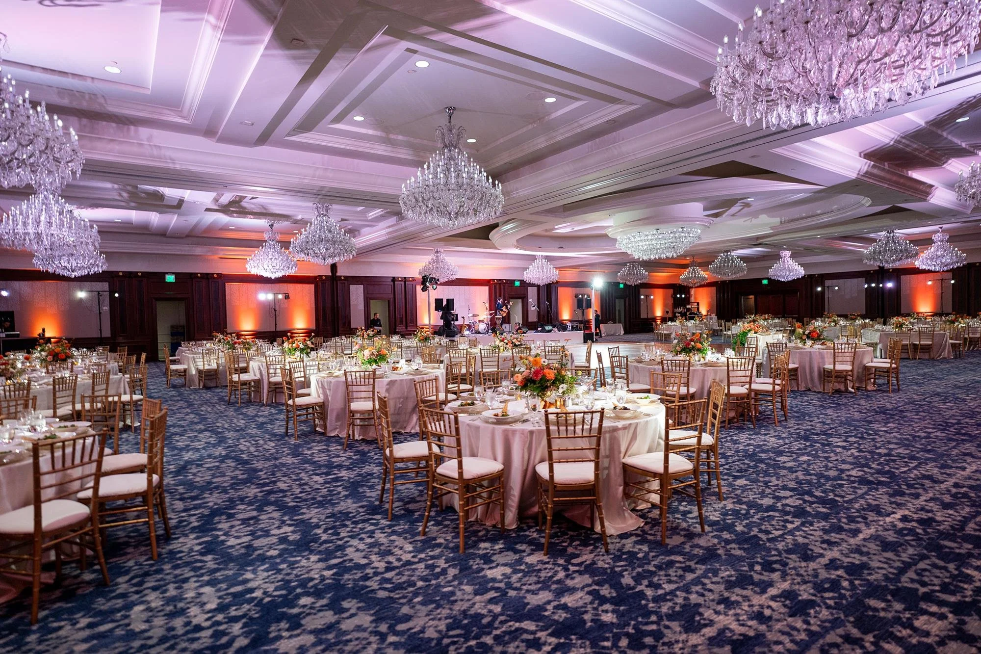 Wedding reception in the Grand Ballroom at Four Seasons Westlake with orange and yellow florals