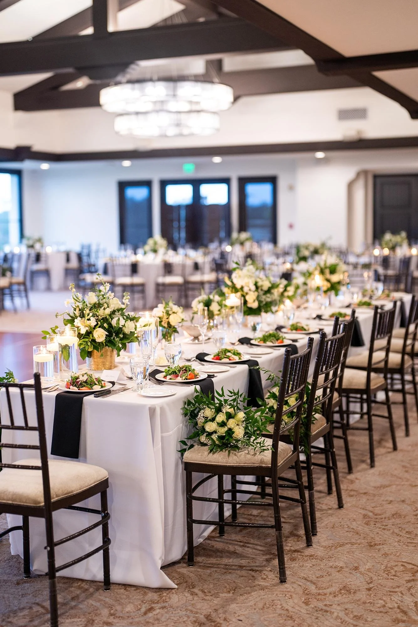 Wedding reception head table with white rose centerpieces at Palos Verdes Golf Club