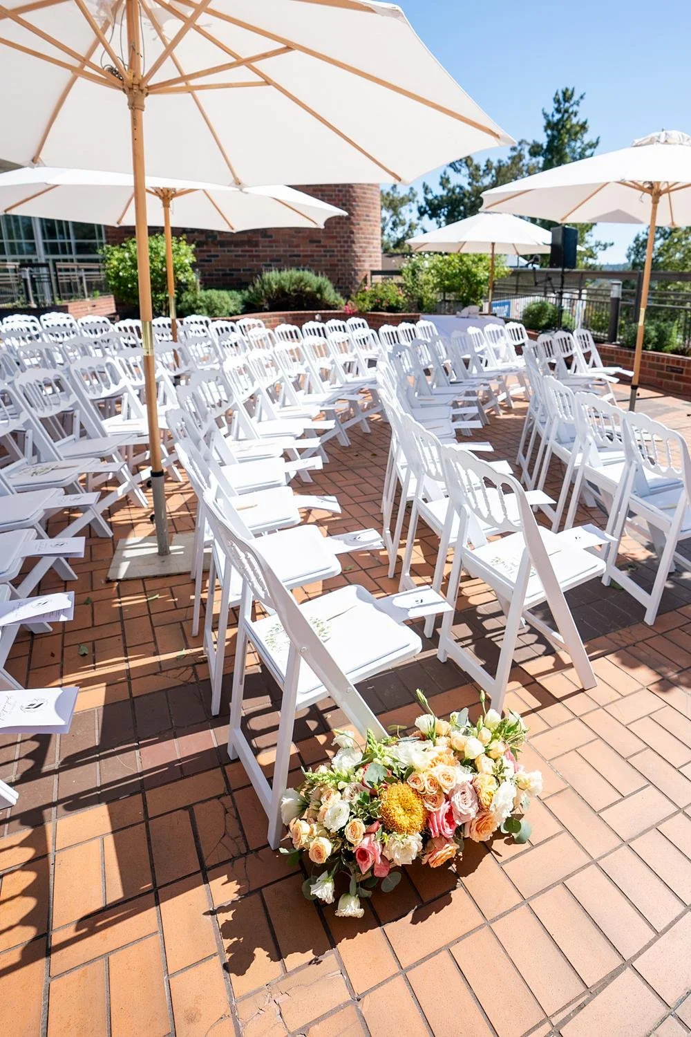 Wedding ceremony detail of aisle treatment with orange florals at Stephen Wise Temple