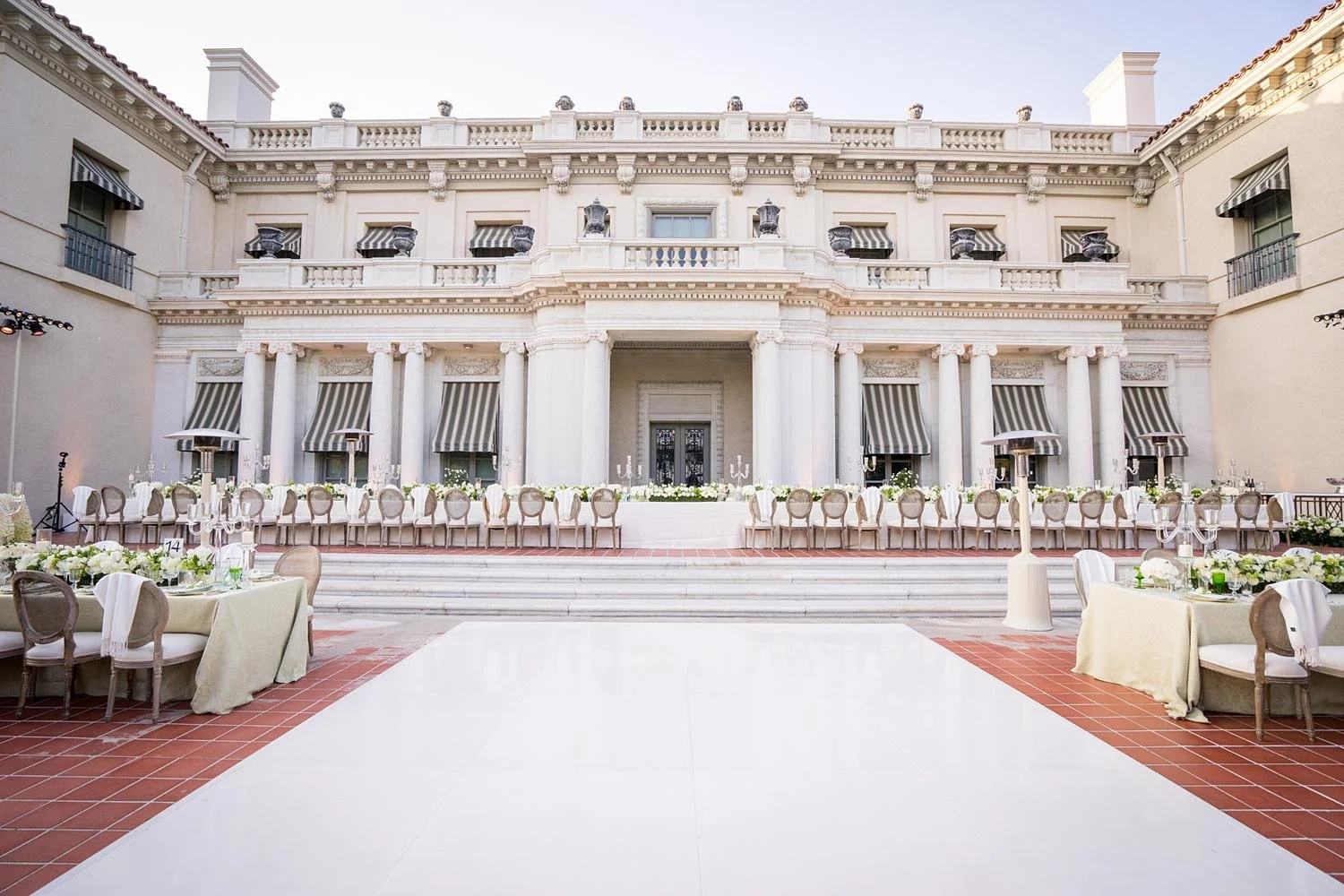 Wide view of head table in front of estate facade during South Terrace wedding reception at Huntington Library