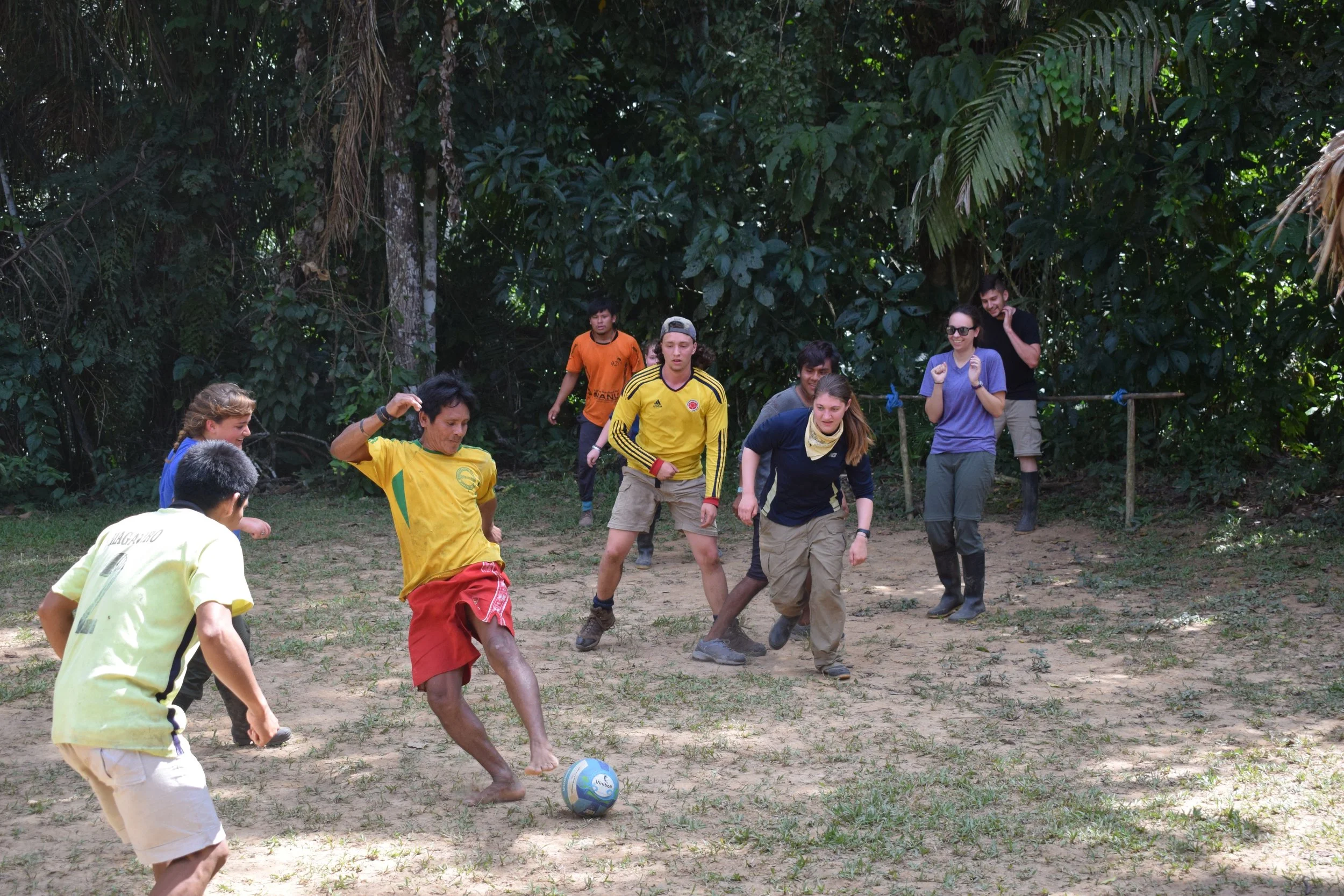 Trip participant playing soccer with some of the locals.