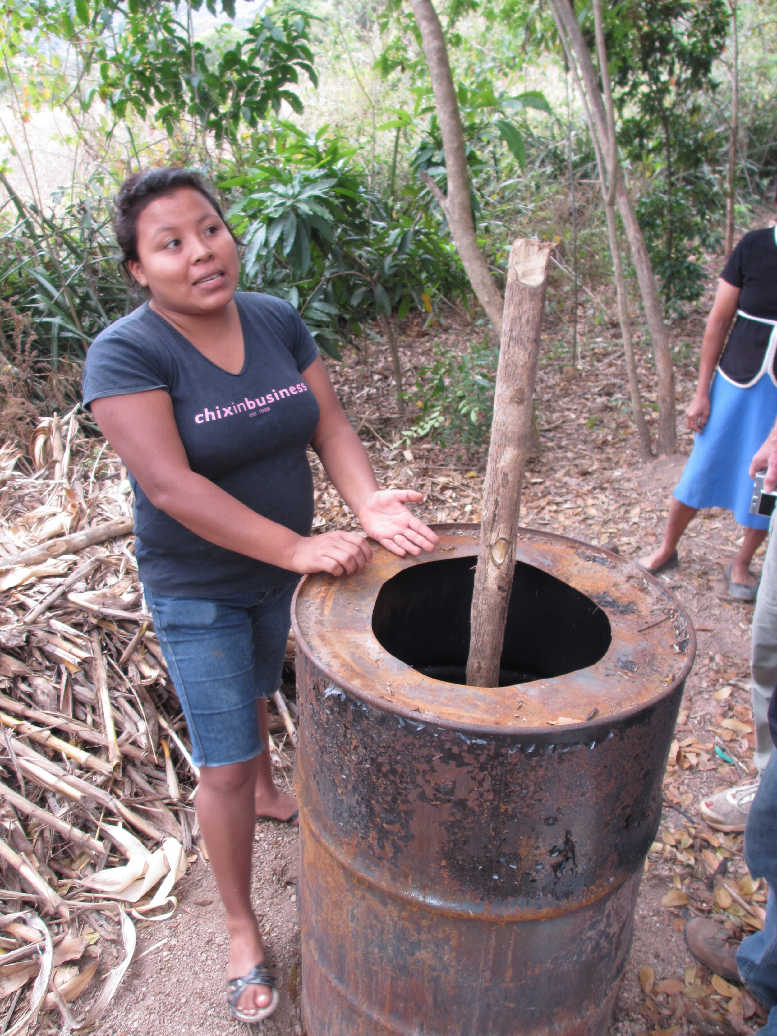 Glenda Prepares a Barrel for Charcoal Briquette Production